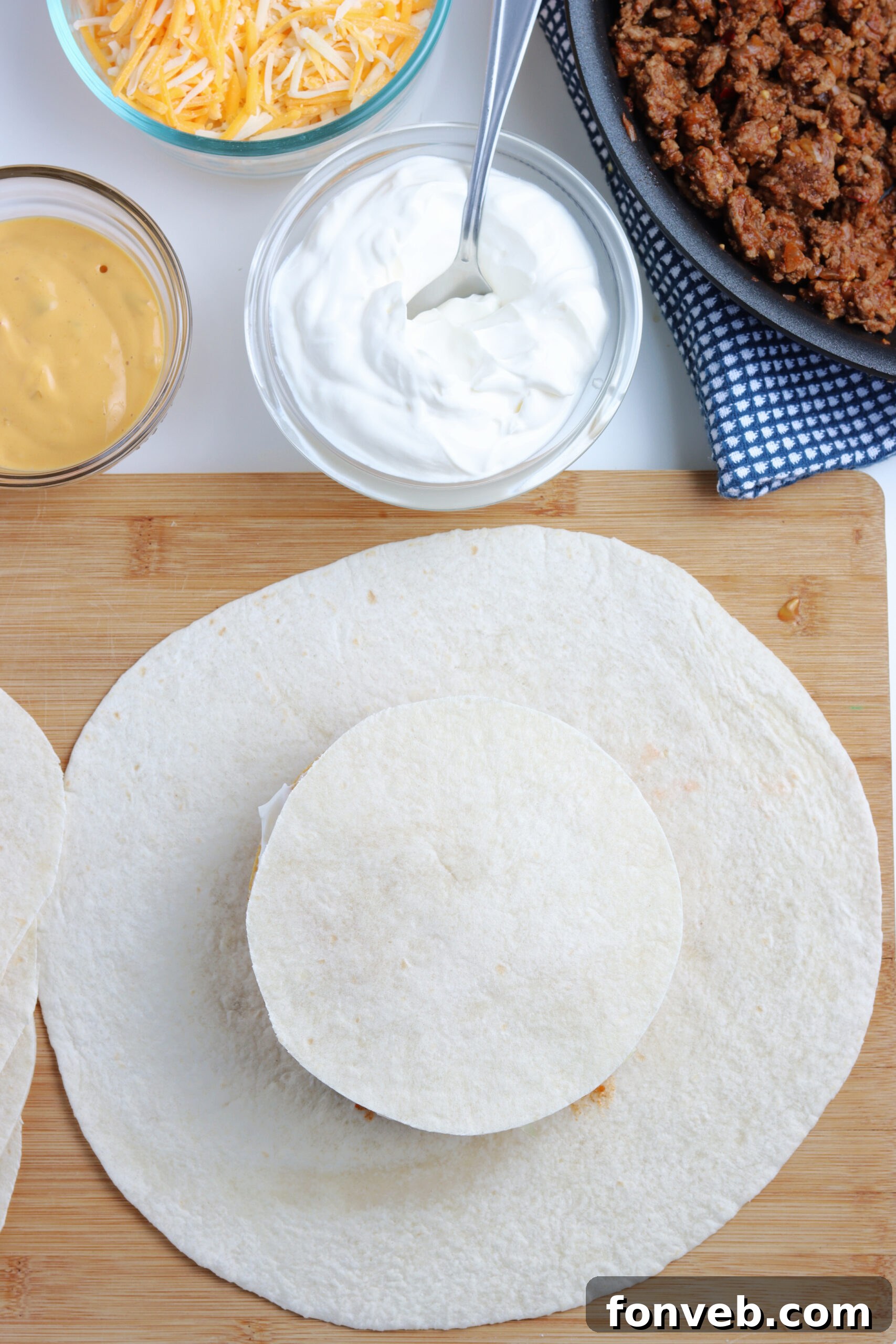 Ultimate Crispy Fold 10 The ground beef mixture cooking in a skillet, seasoned and ready.