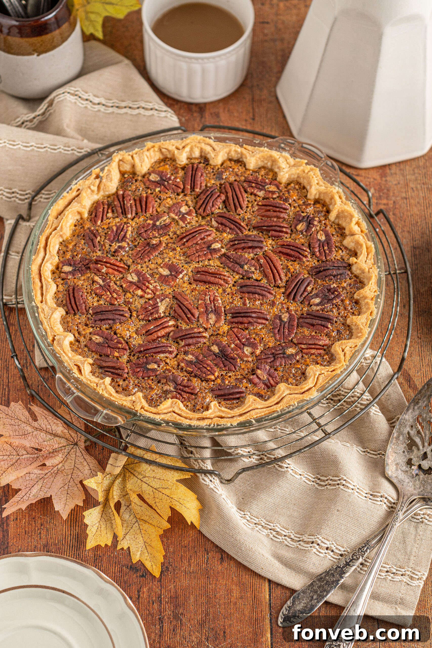 Bourbon Pecan Indulgence 3 An overhead view of the pecan pie in a glass pie dish cooling on a wire rack.