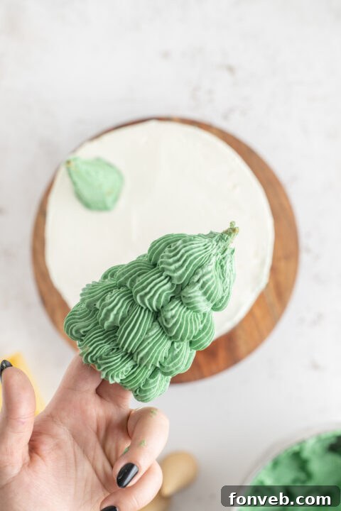 Layered cake with white frosting on top, ready for final decoration.