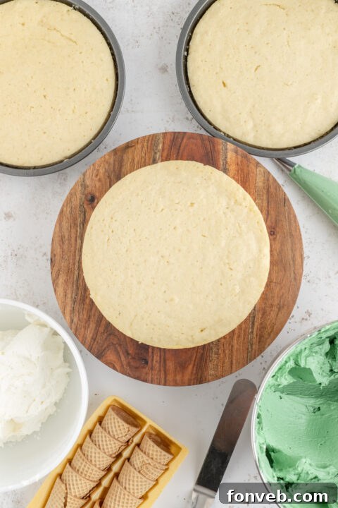 A bowl of green buttercream frosting with a piping bag.