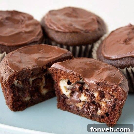 Decadent Cheesecake Stuffed Chocolate Cupcakes with a creamy filling