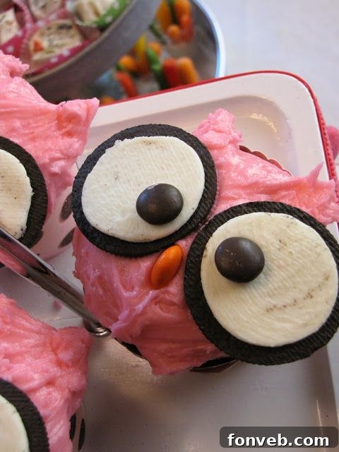 Whimsical Owl Cupcakes decorated with Oreo eyes and candy corn beaks