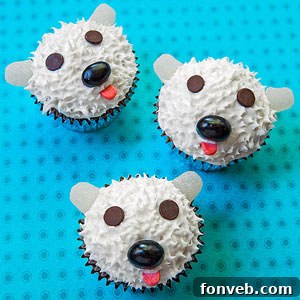 Fluffy Polar Bear Cupcakes with white frosting and marshmallow ears