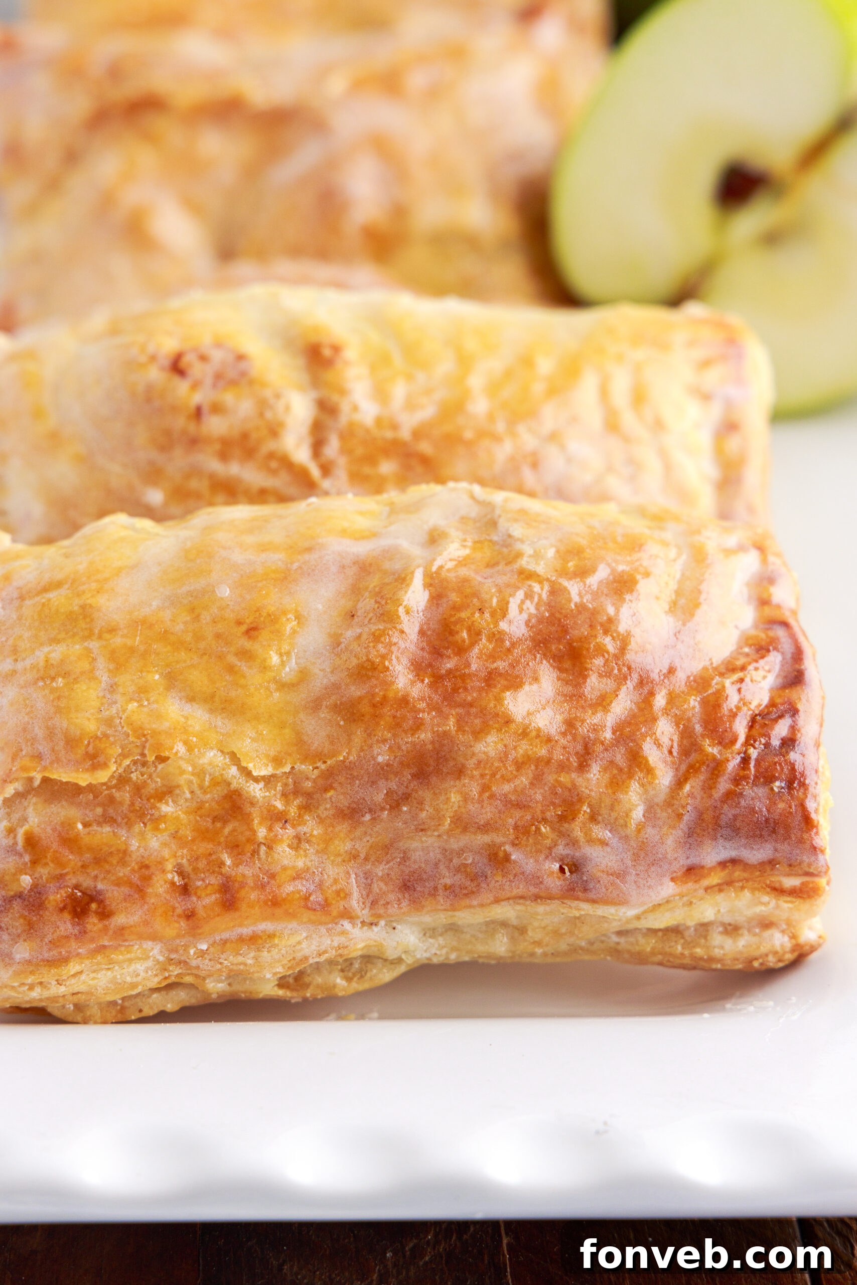 View of an apple hand pie showing the glaze and golden brown crust. 