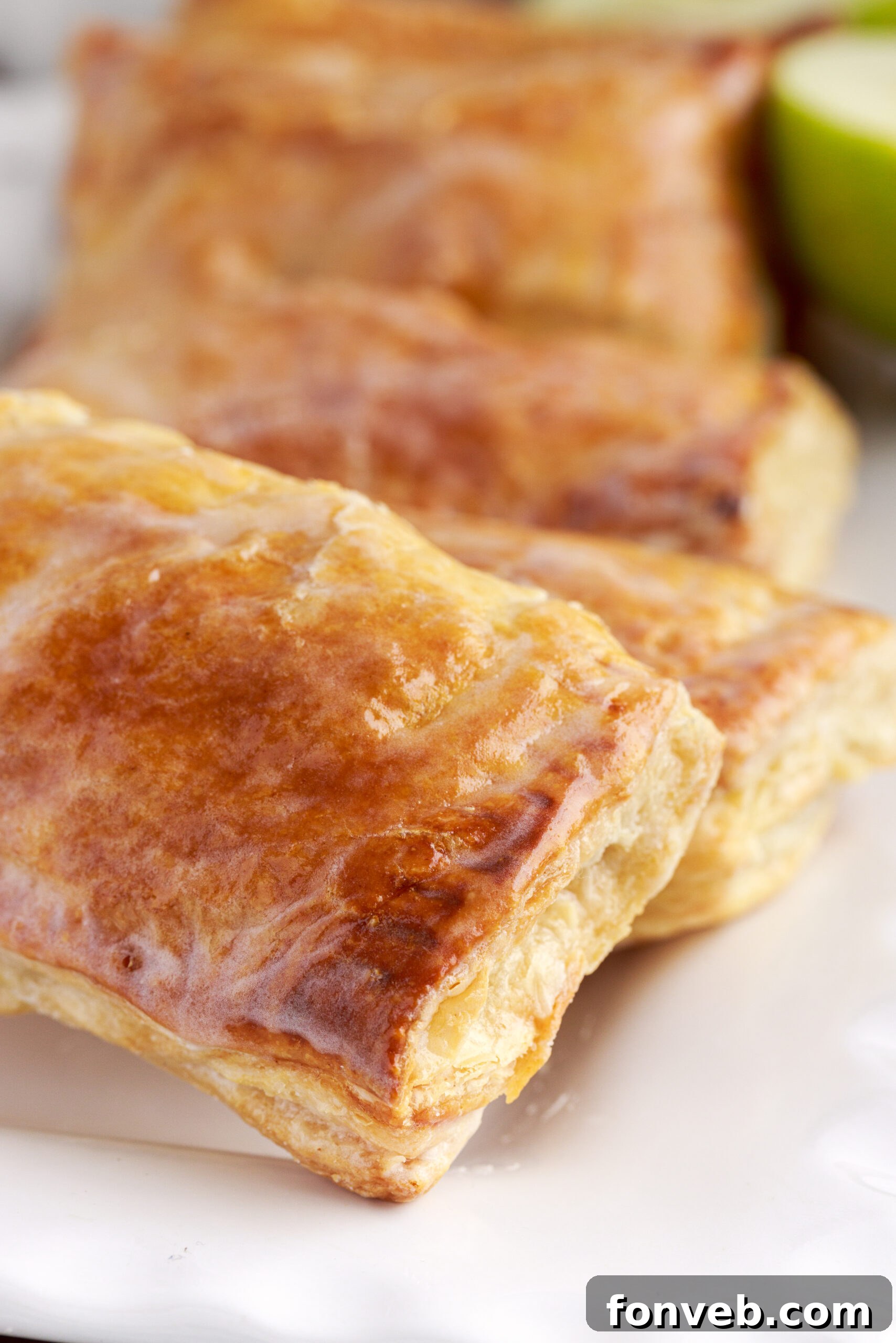 Overhead view of an apple hand pie showing the glaze and golden brown crust. 