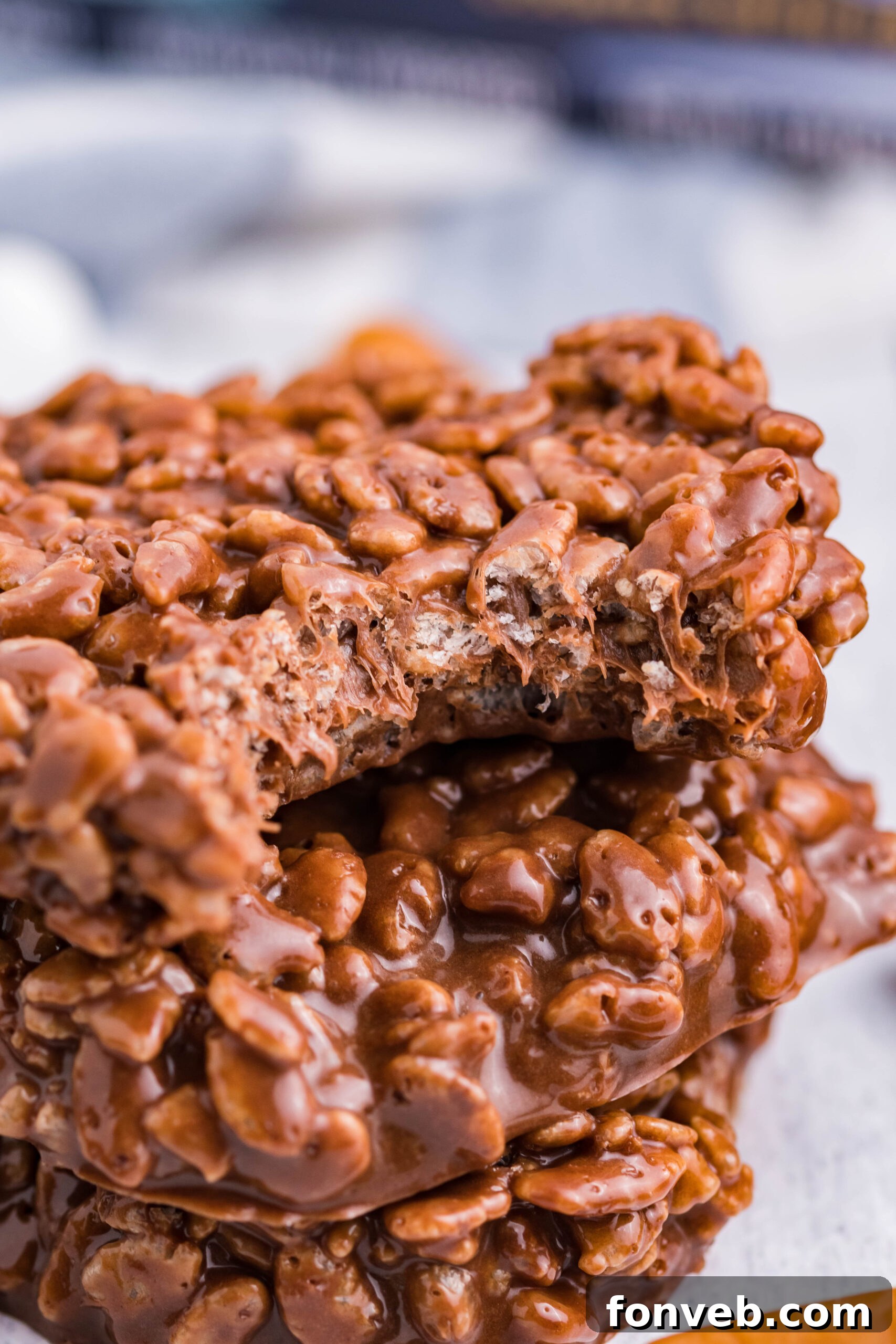 Another appealing view of three neatly stacked Star Crunch copycat cookies on a light-colored wooden backdrop, showcasing their perfect shape and the enticing texture of the top cookie with a missing piece.