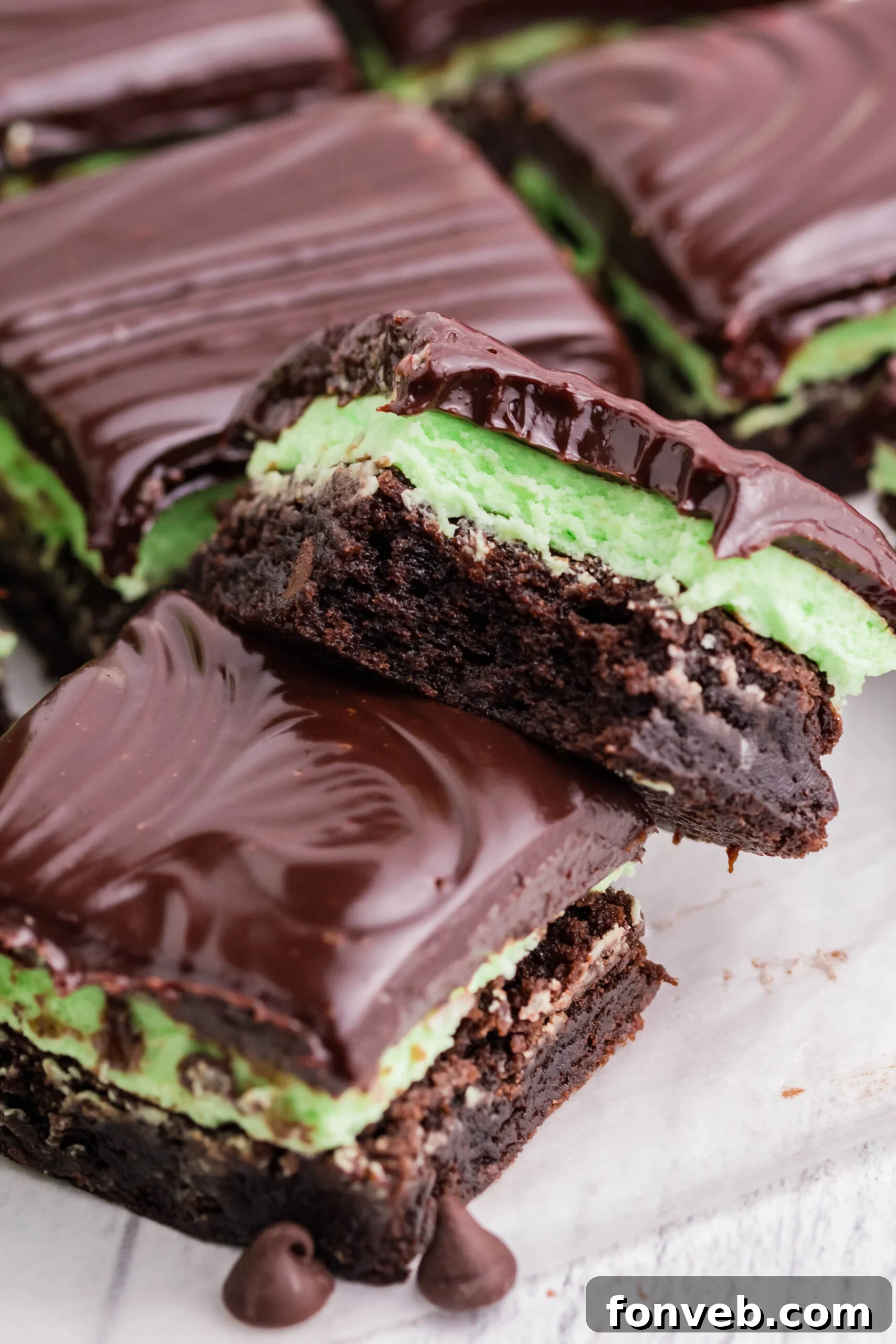 A brownie stacked on top of another with a bite removed.