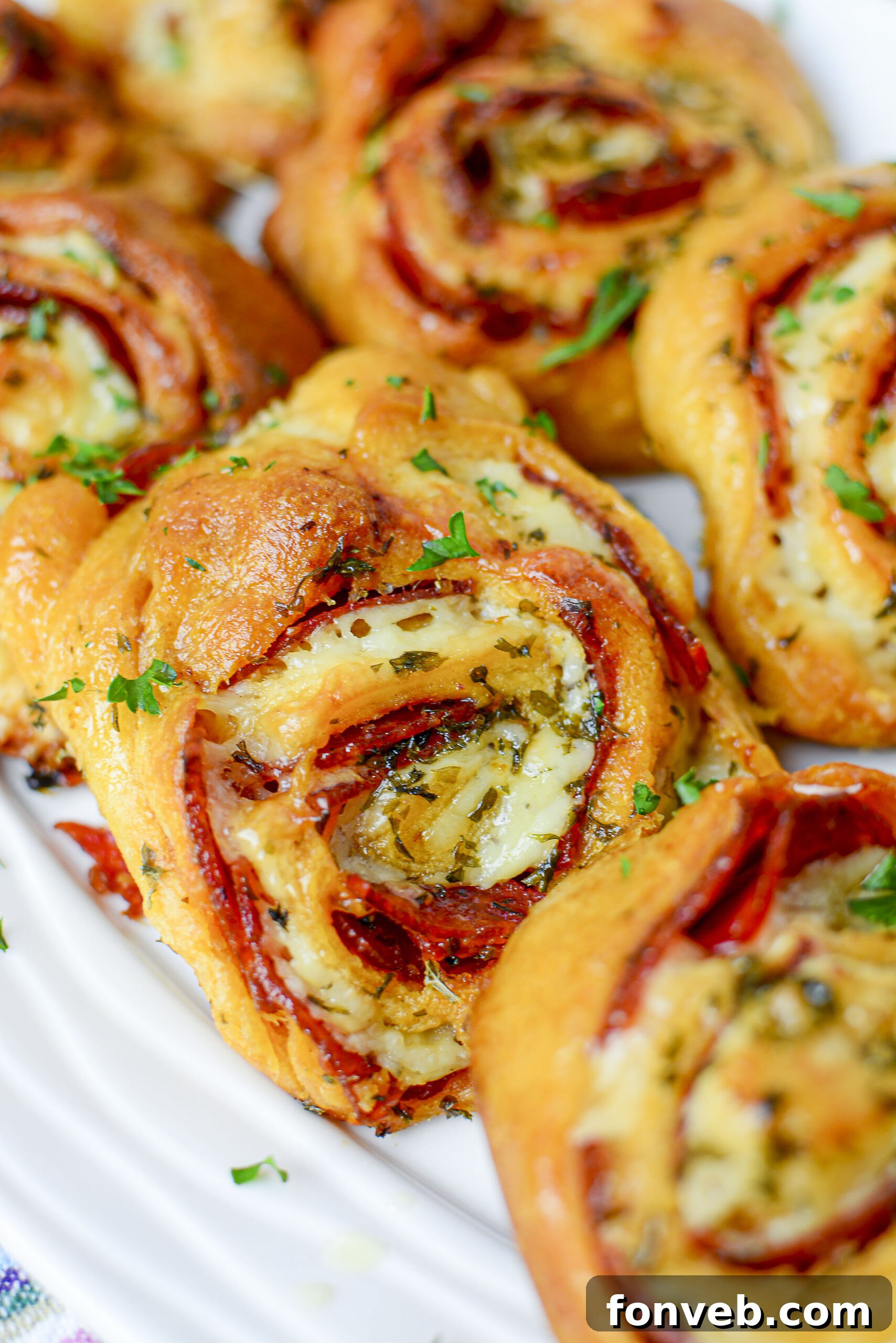 Swirled Pizza Bites 2 Delicious pizza pinwheels arranged on a serving platter, ready for a party.