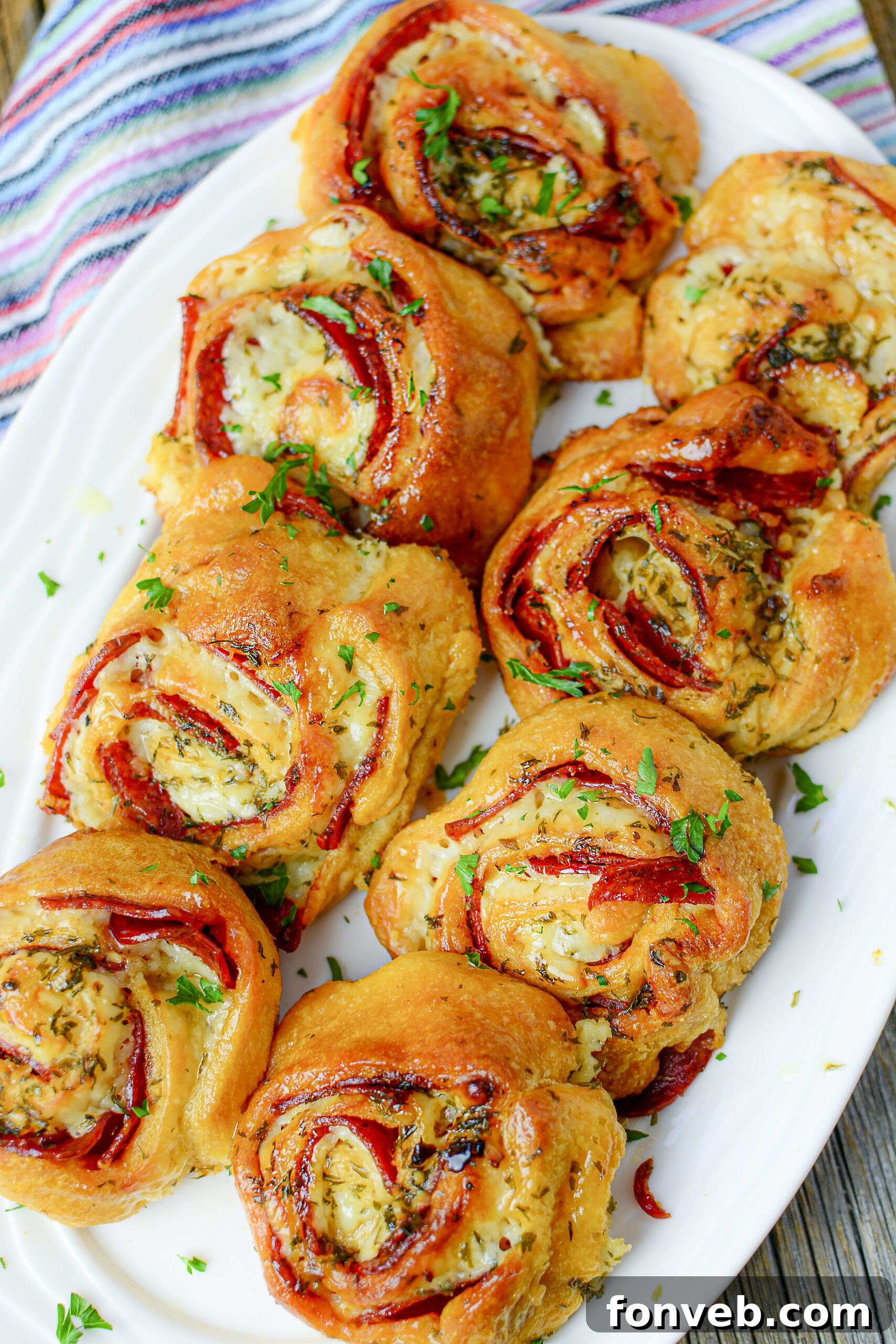Swirled Pizza Bites 4 A selection of pizza pinwheels cooling on a rack, highlighting their perfectly browned edges.