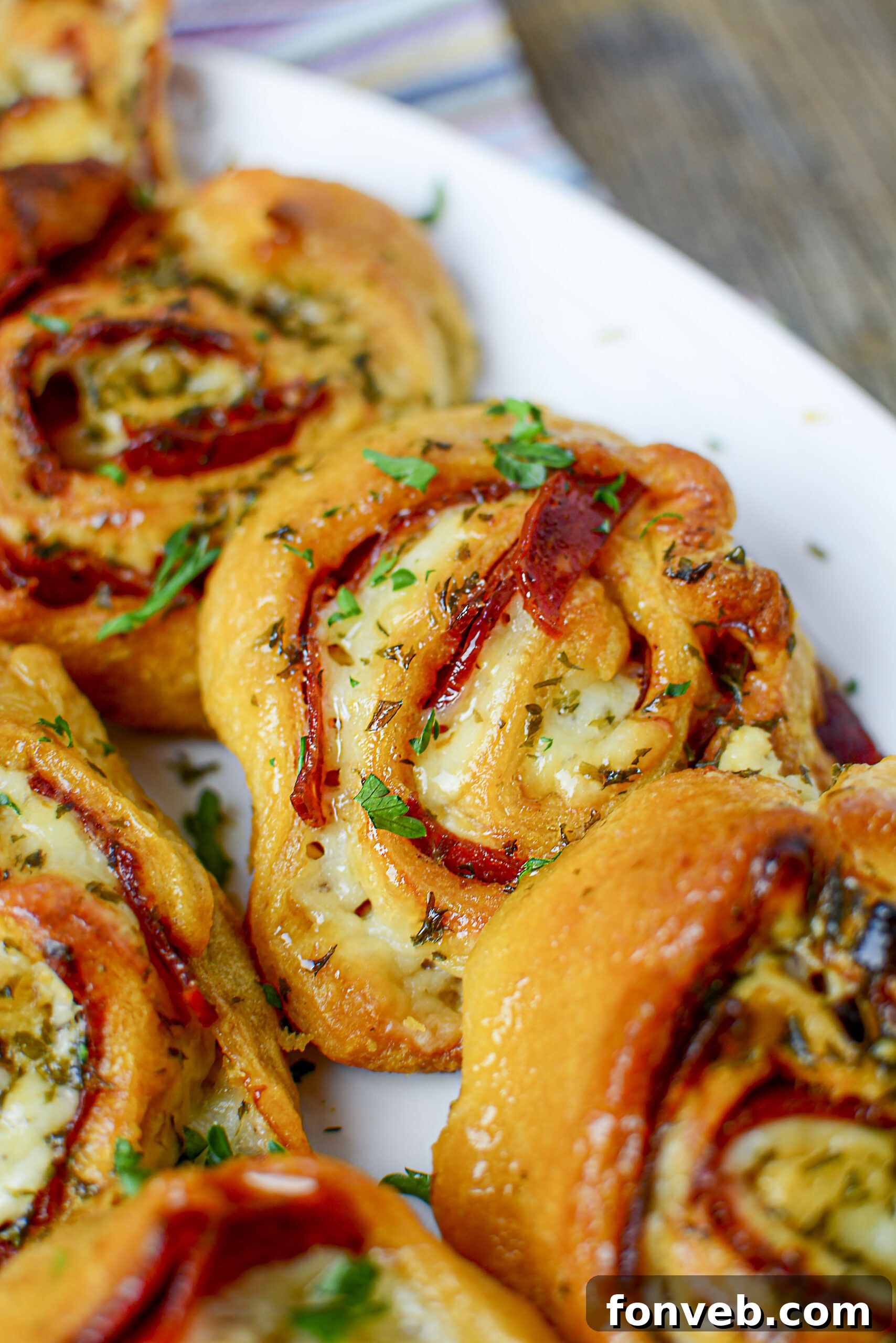 Swirled Pizza Bites 5 Ingredients laid out for making pizza pinwheels: crescent roll dough, pizza sauce, pepperoni, and mozzarella cheese.