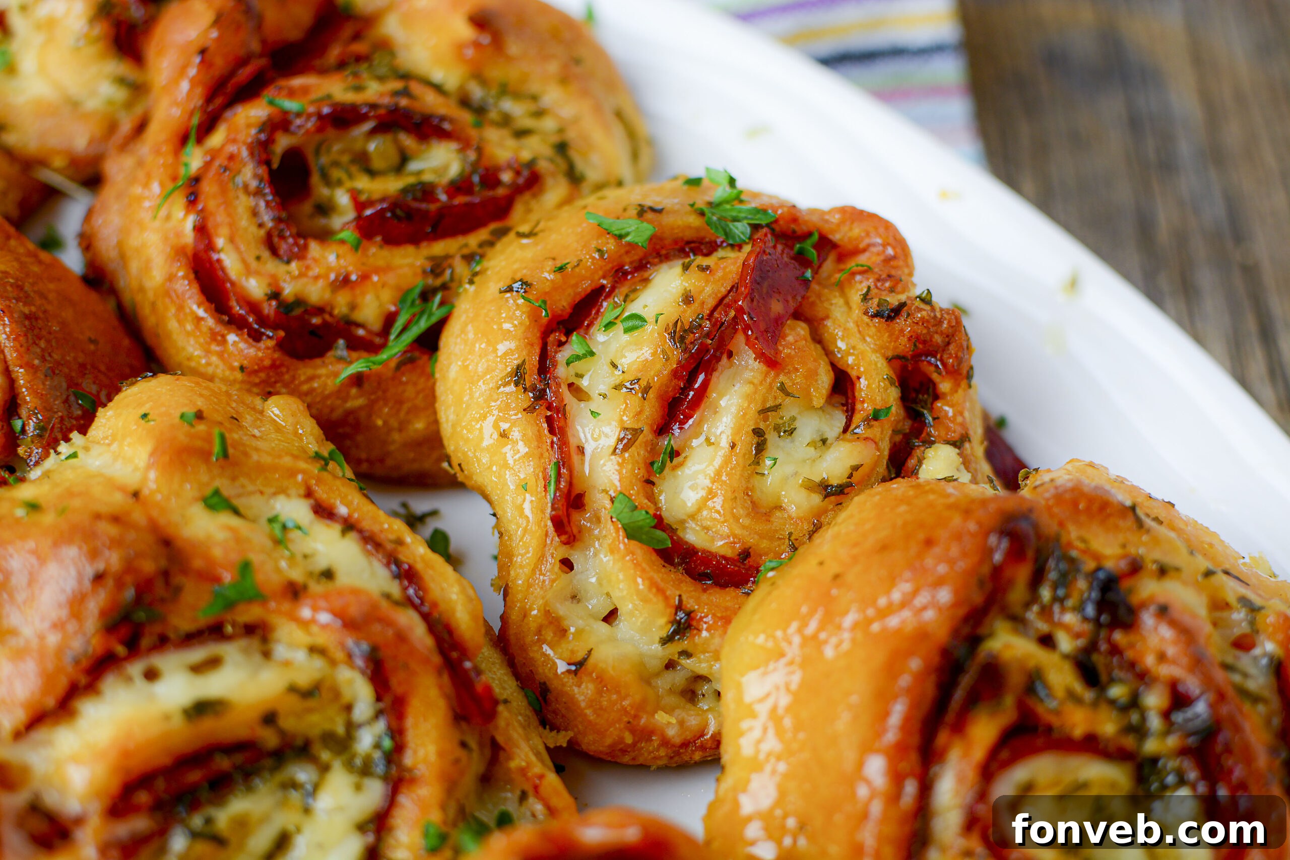 Swirled Pizza Bites 6 Freshly baked pizza pinwheels in a white baking pan, ready to be served.
