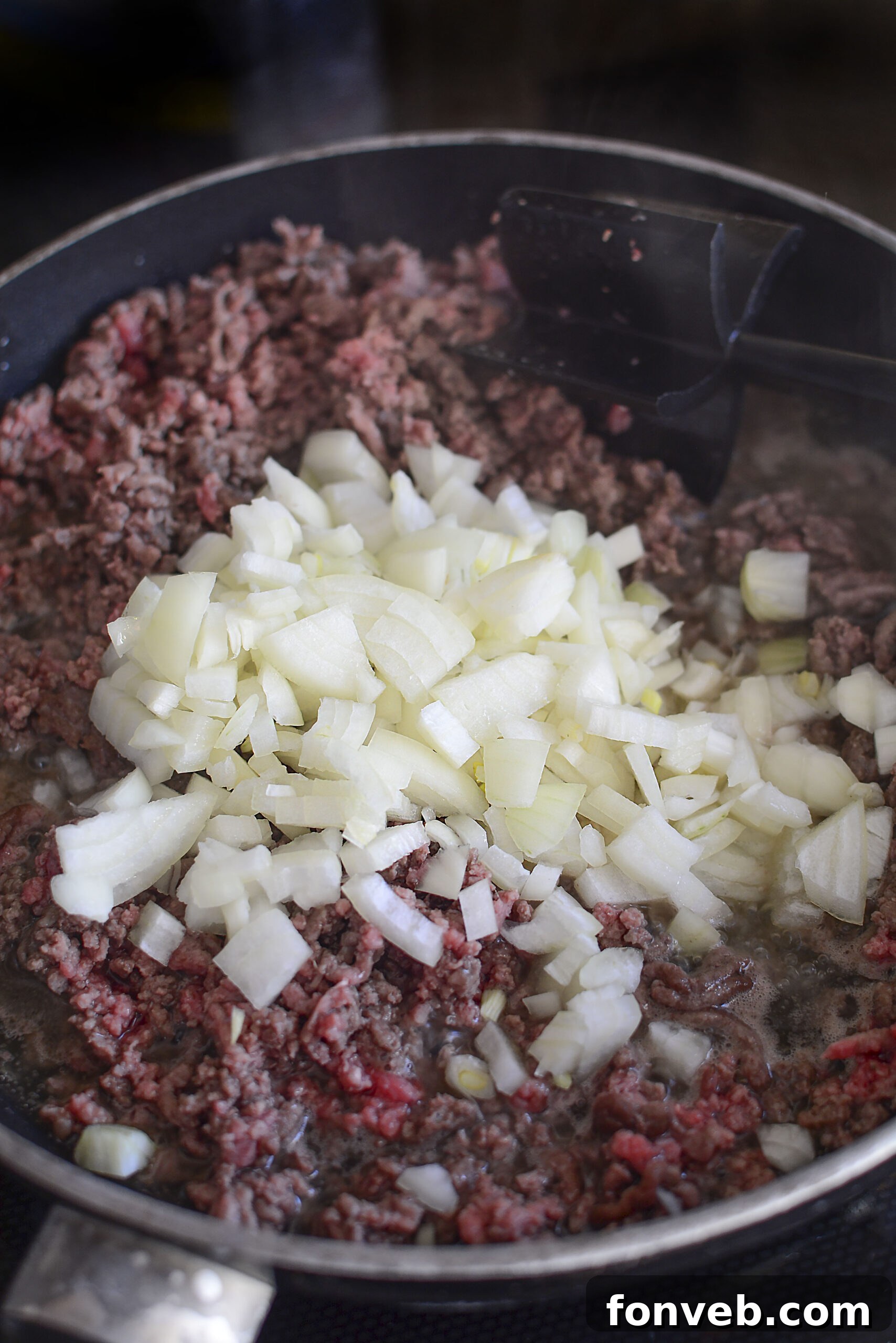 Golden Cheesy Beef and Potato Bake 6 Ground beef and potato casserole layers being assembled in a white baking dish.