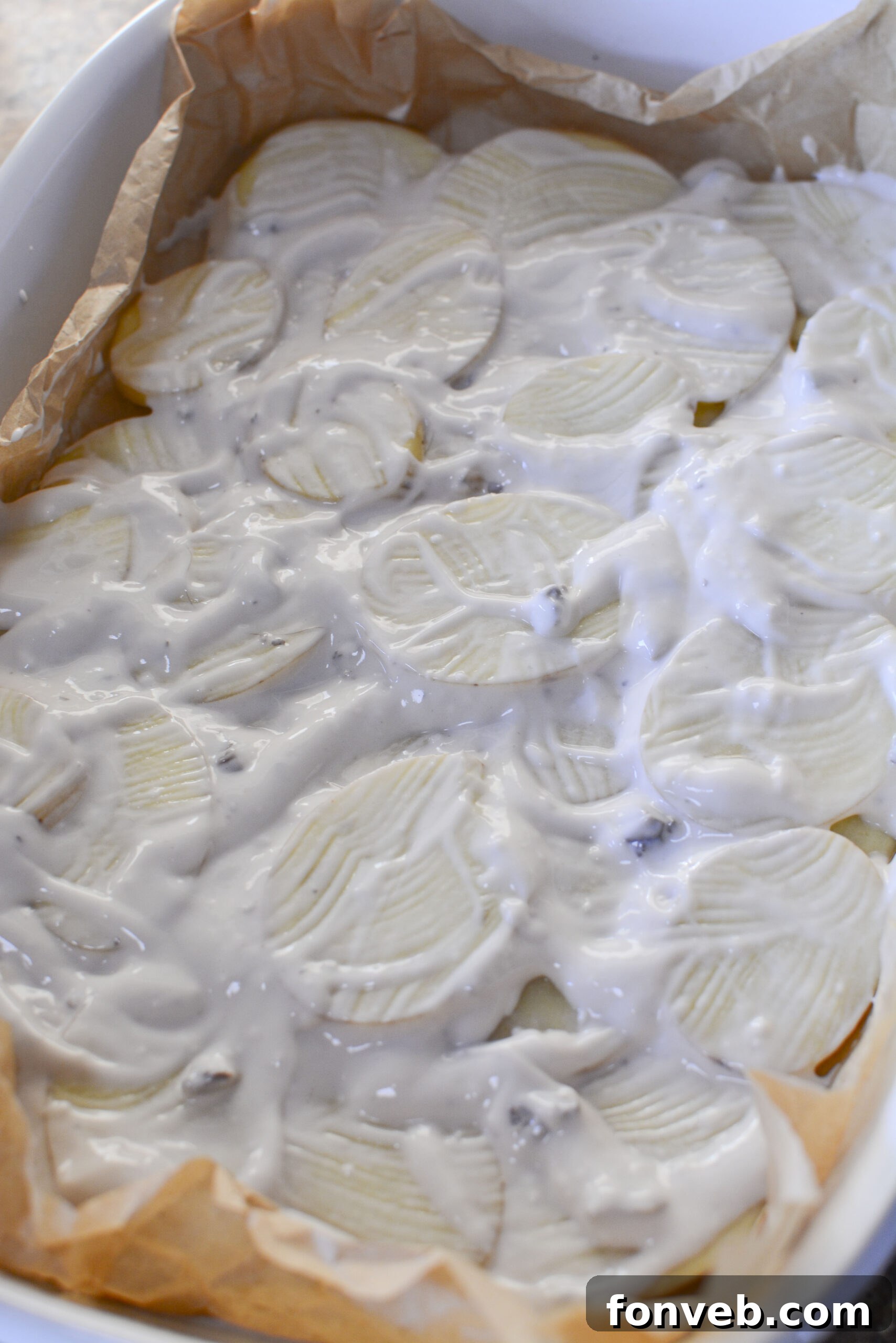 Golden Cheesy Beef and Potato Bake 8 Browning ground beef with chopped onions in a skillet.