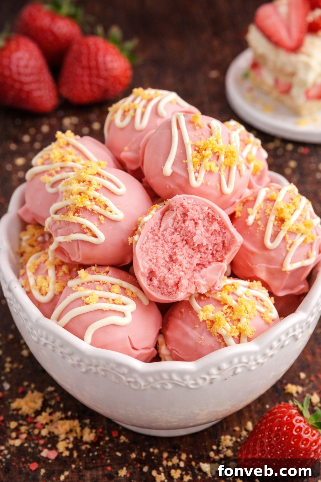 Strawberry Shortcake Truffles in a white bowl on a dark wood table