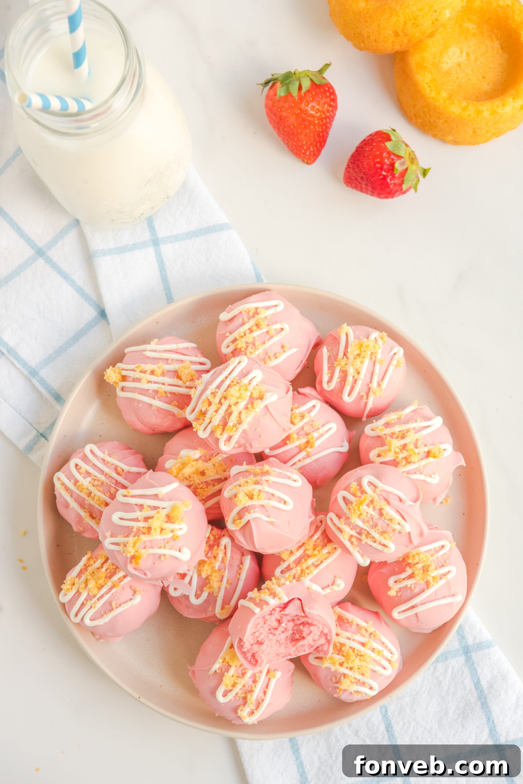 Overhead view of truffles stacked on a white plate.