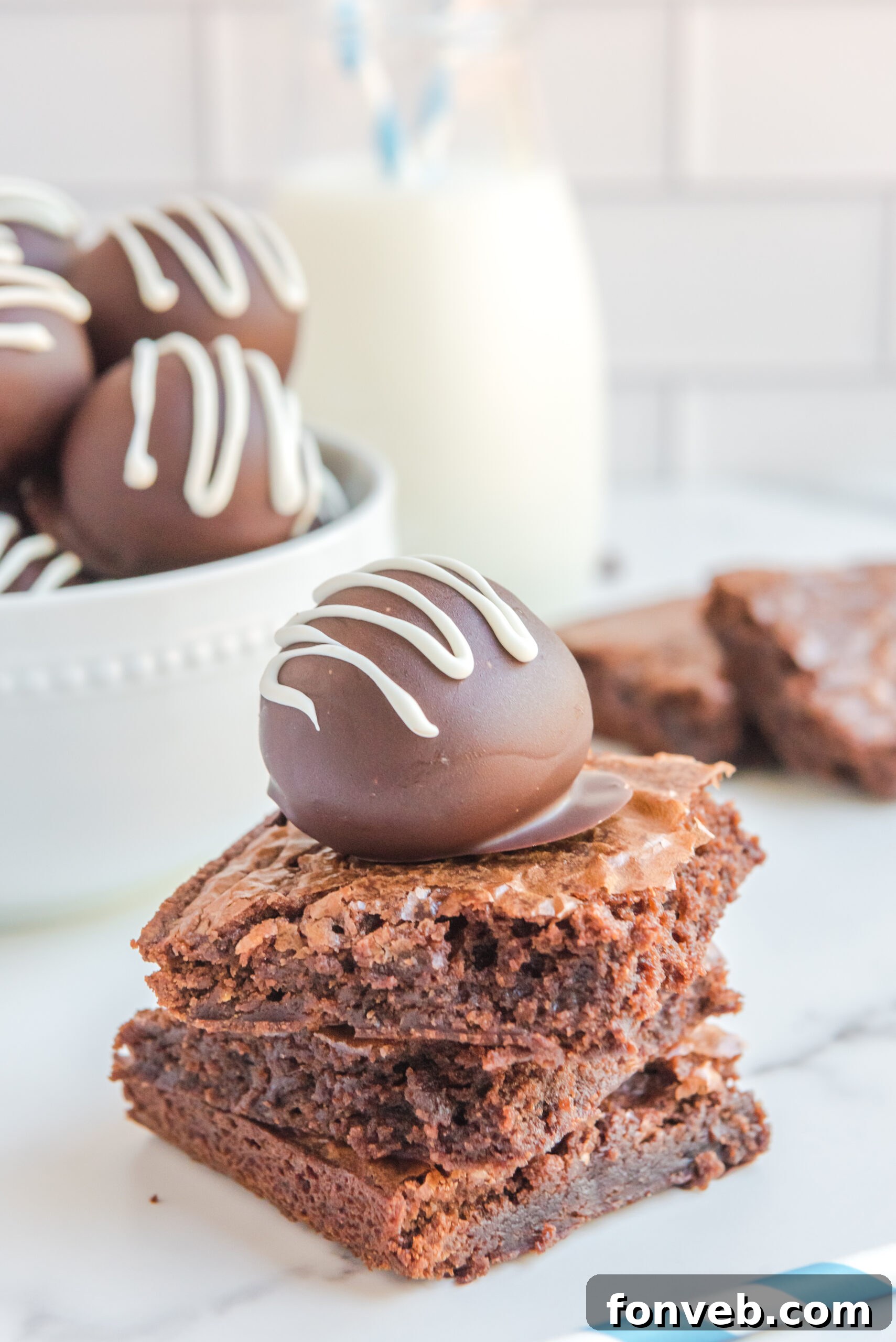 Decadent Brownie Bites 6 A brownie truffle stacked on three brownies.