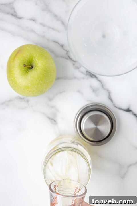 Adding sour mix to the shaker with other ingredients.