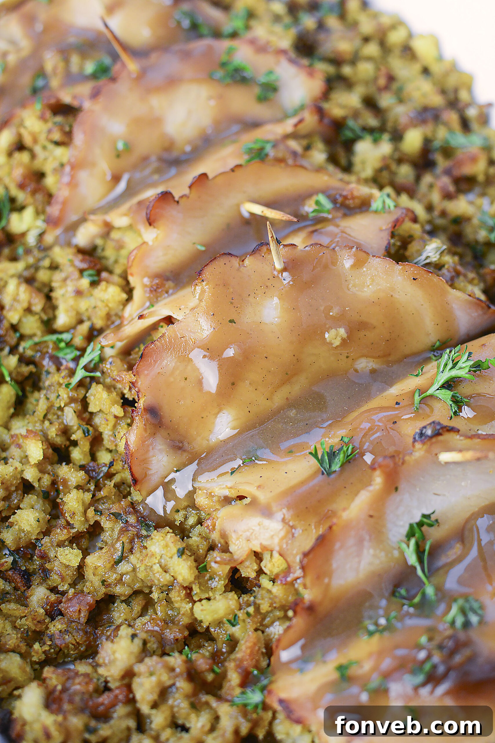 Up Close view of turkey stuffing rolls topped with gravy. 