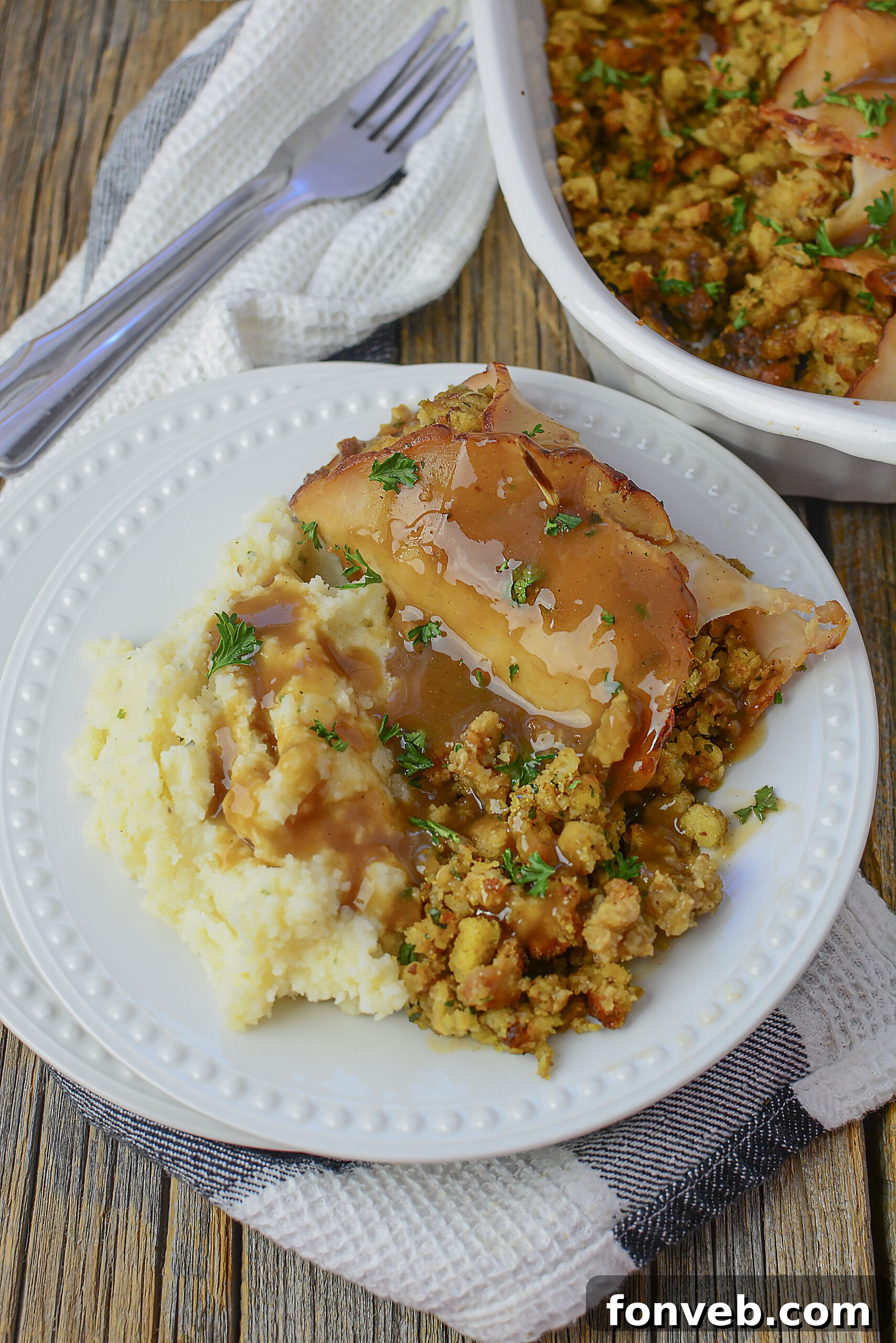 Turkey Stuffing Rolls on a white plate with mashed potatoes and gravy.