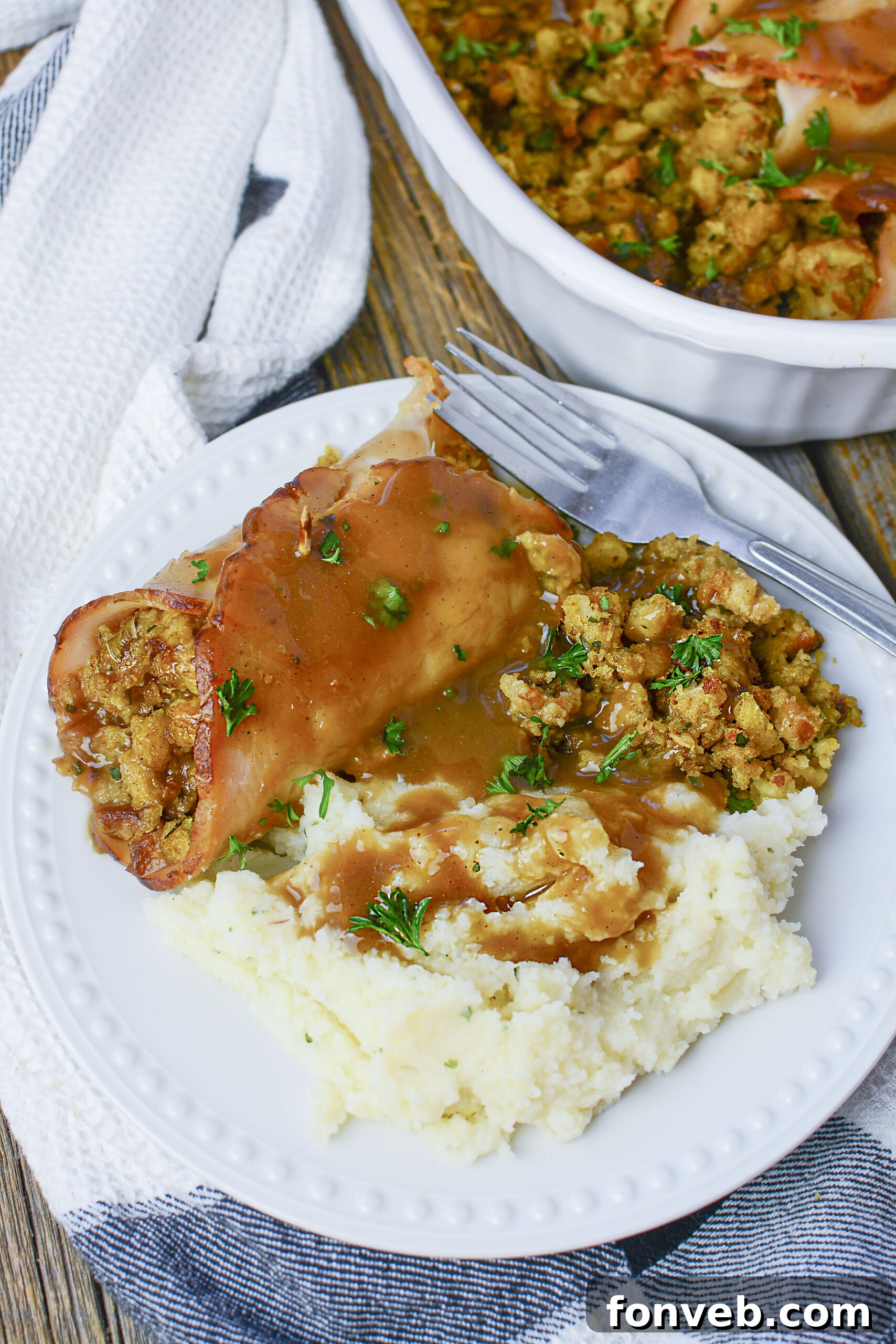 Turkey Stuffing Rolls on a white plate with mashed potatoes and gravy.