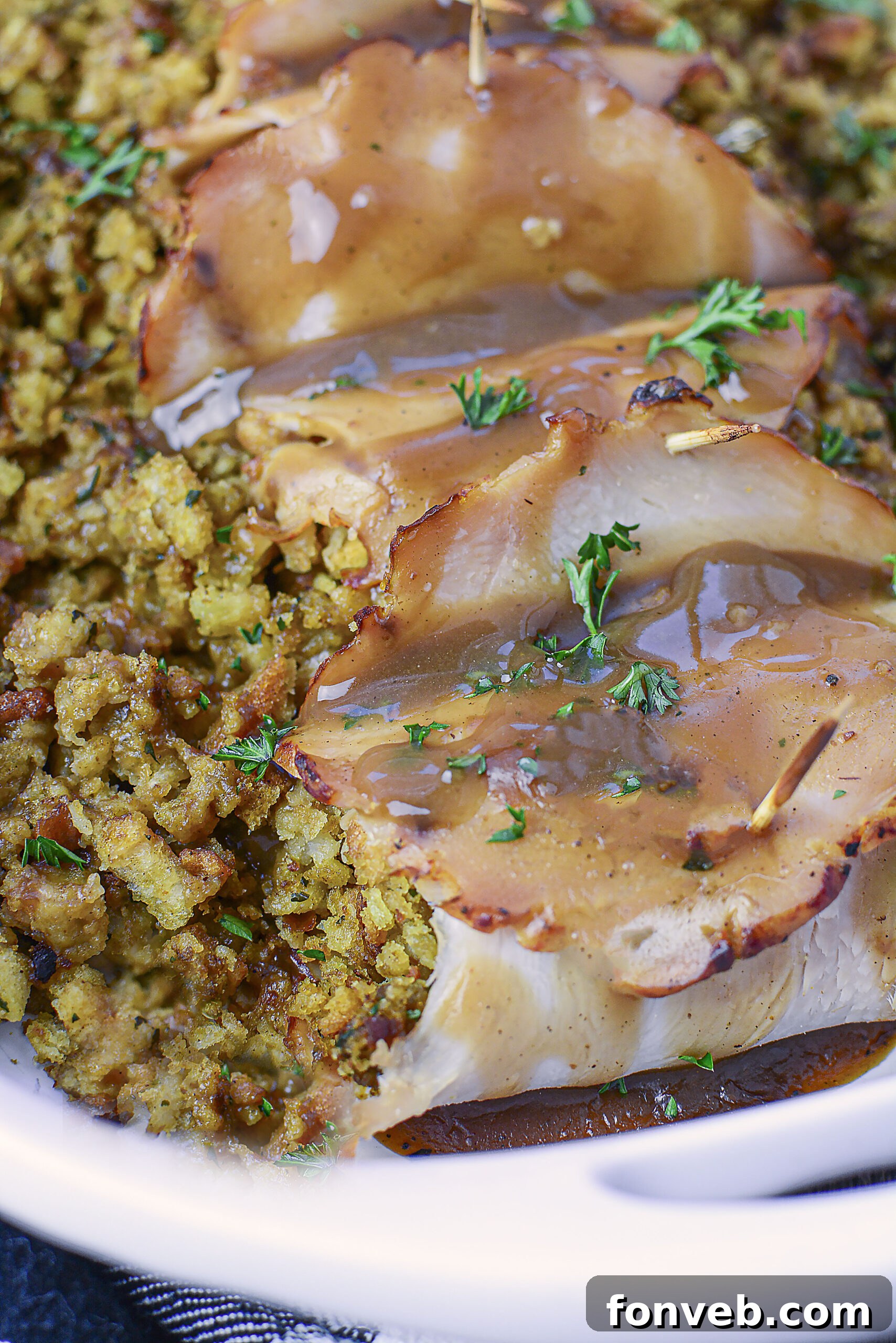 Up Close view of turkey stuffing rolls topped with gravy. 