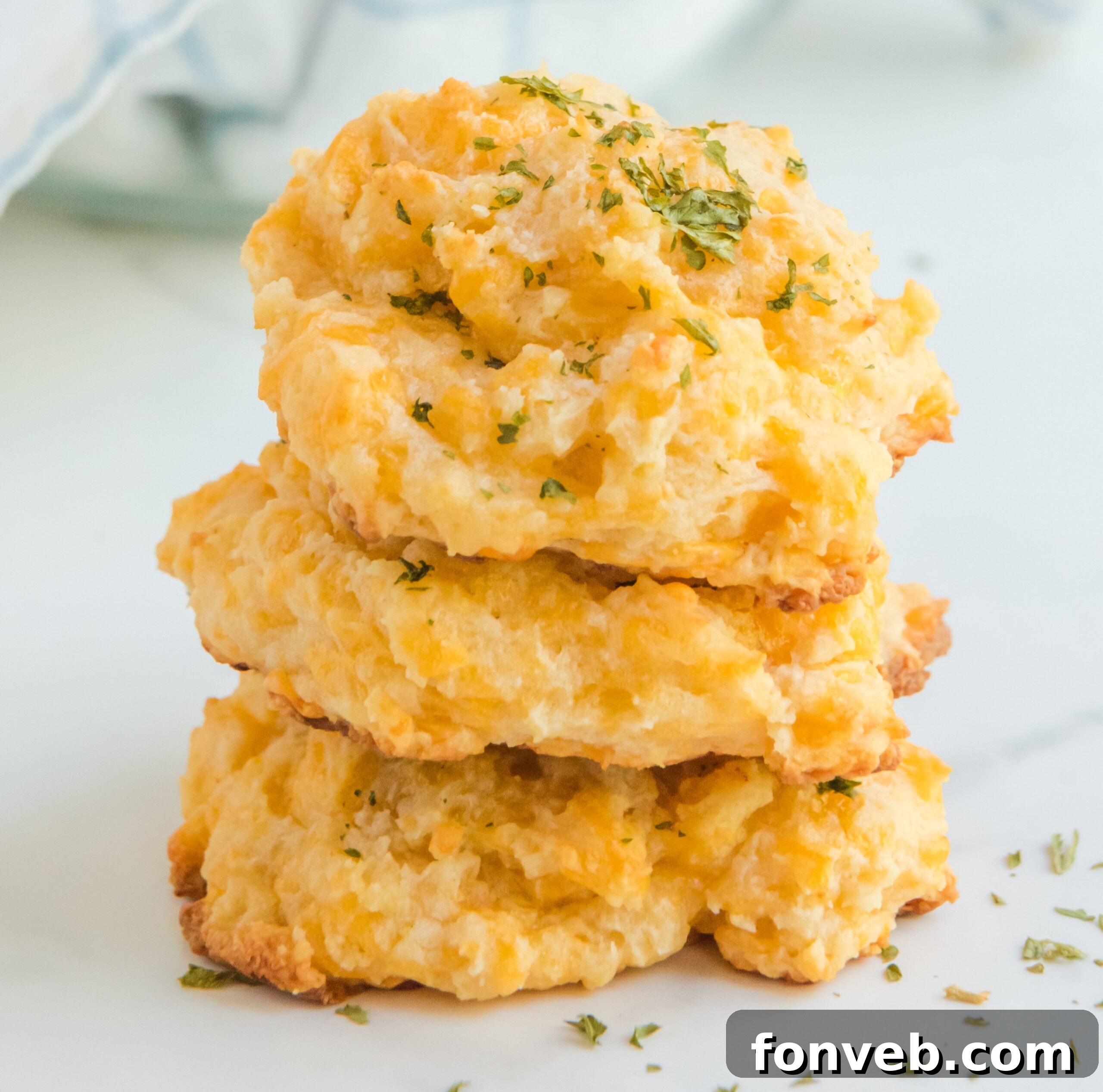 A stack of 3 Red Lobster style cheddar bay biscuits, showcasing the top crust