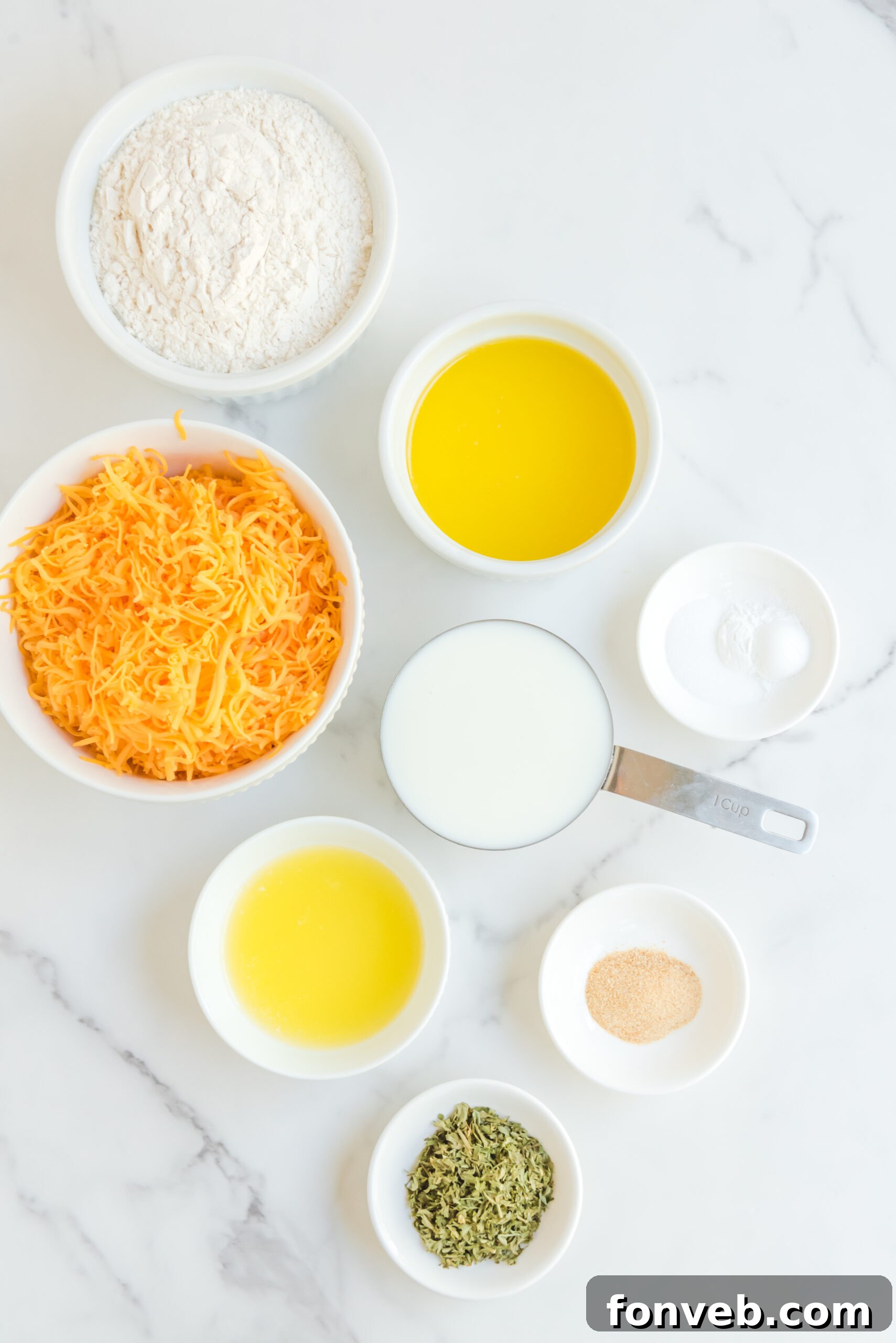 Overhead view of the individual ingredients needed for Copycat Red Lobster Cheddar Bay Biscuits, neatly arranged