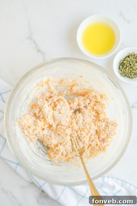 Close-up of baked Cheddar Bay Biscuits on a baking sheet, golden brown