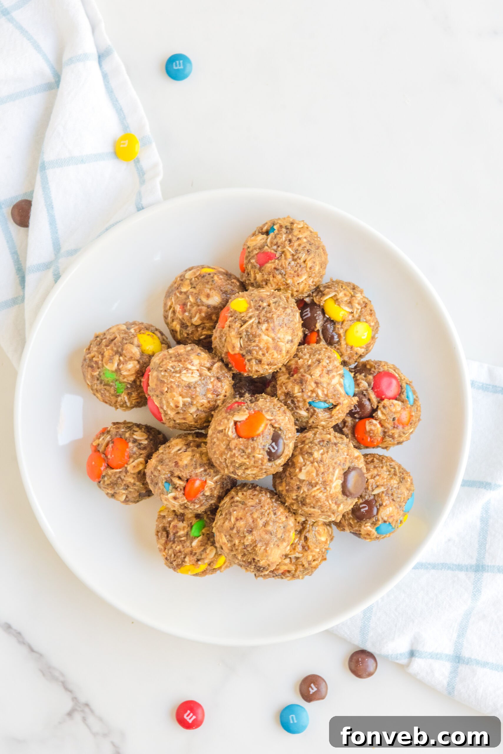 Overhead view of No Bake M&M Energy Balls in a white dish. 