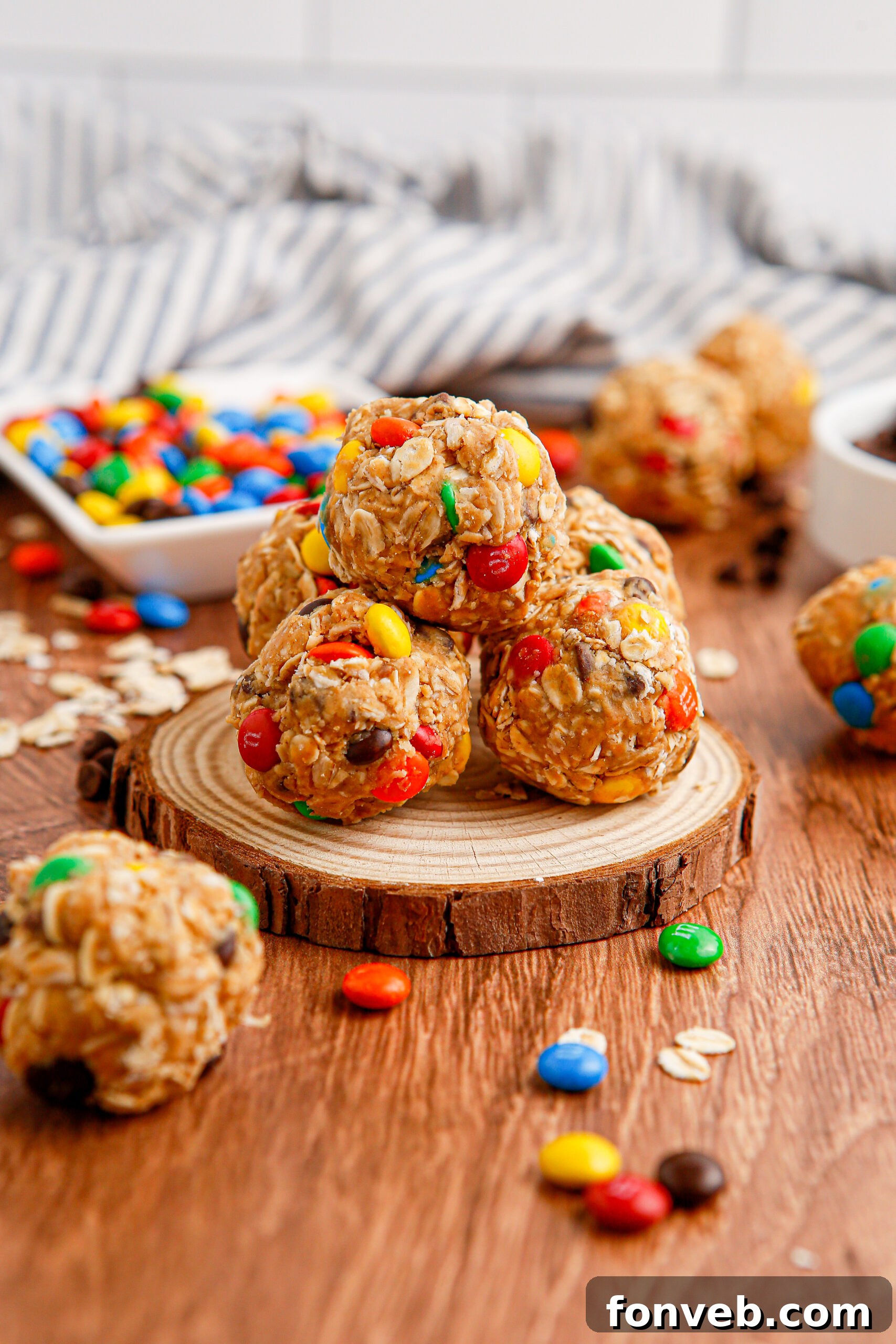 Close up view of No Bake M&M Energy balls on a wooden table 