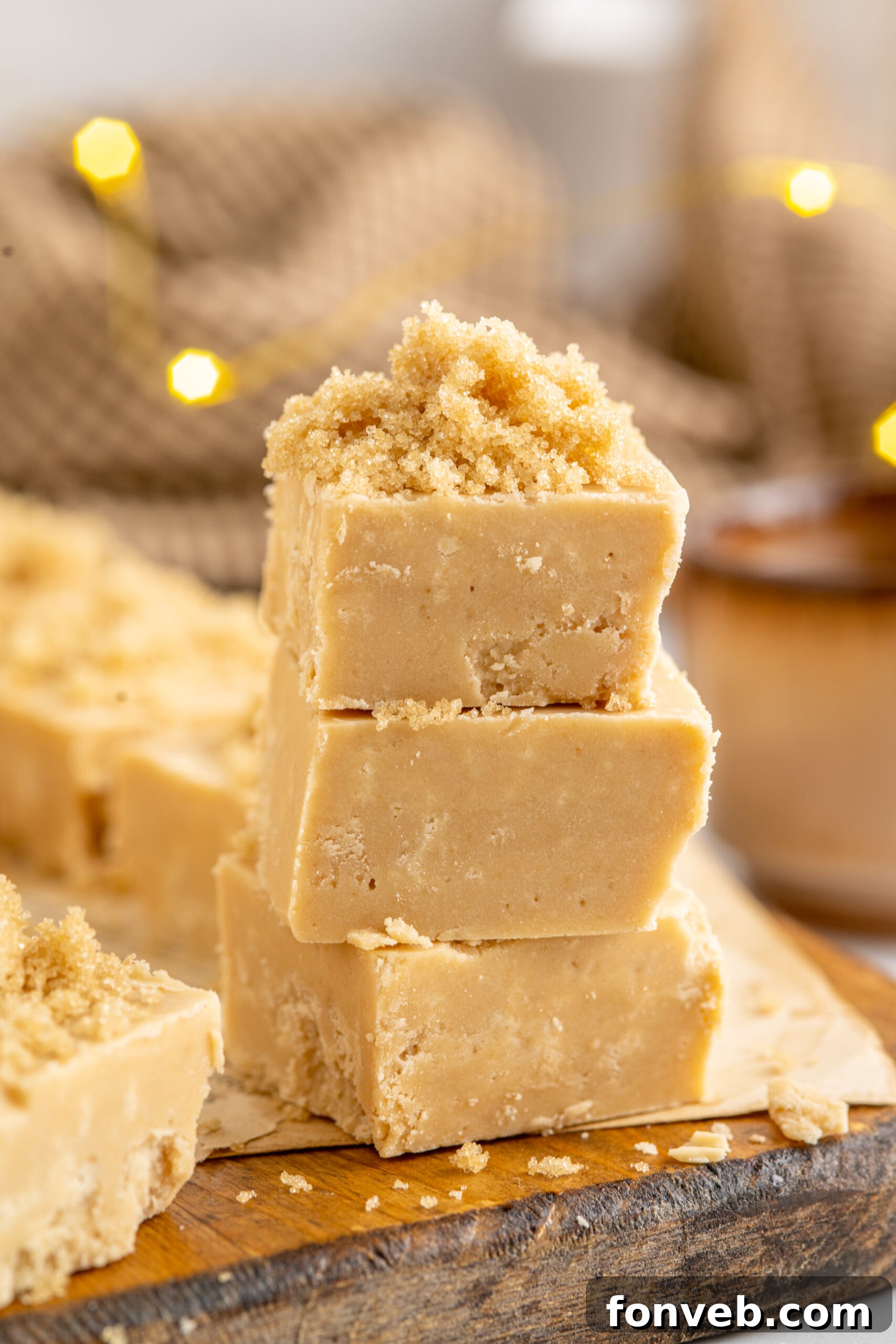 Side view of three pieces of Penuche Fudge stacked, showing its creamy texture.