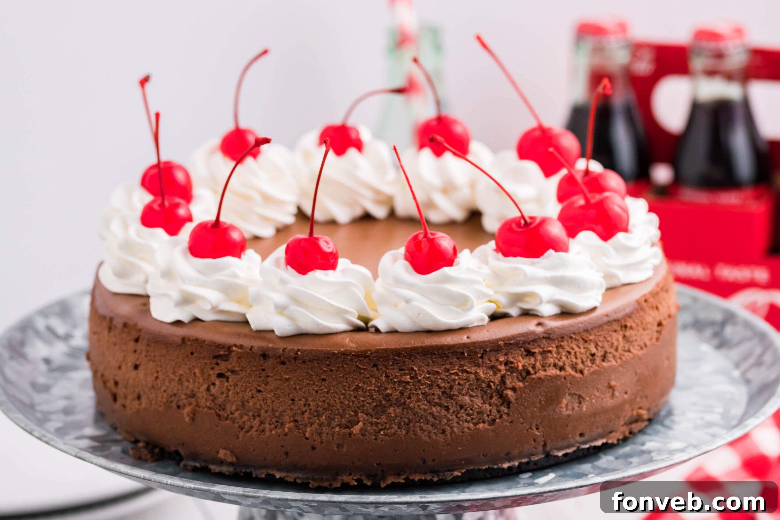 Top-down view of Coca Cola Cheesecake on a galvanized cake pan, showcasing the inviting surface.