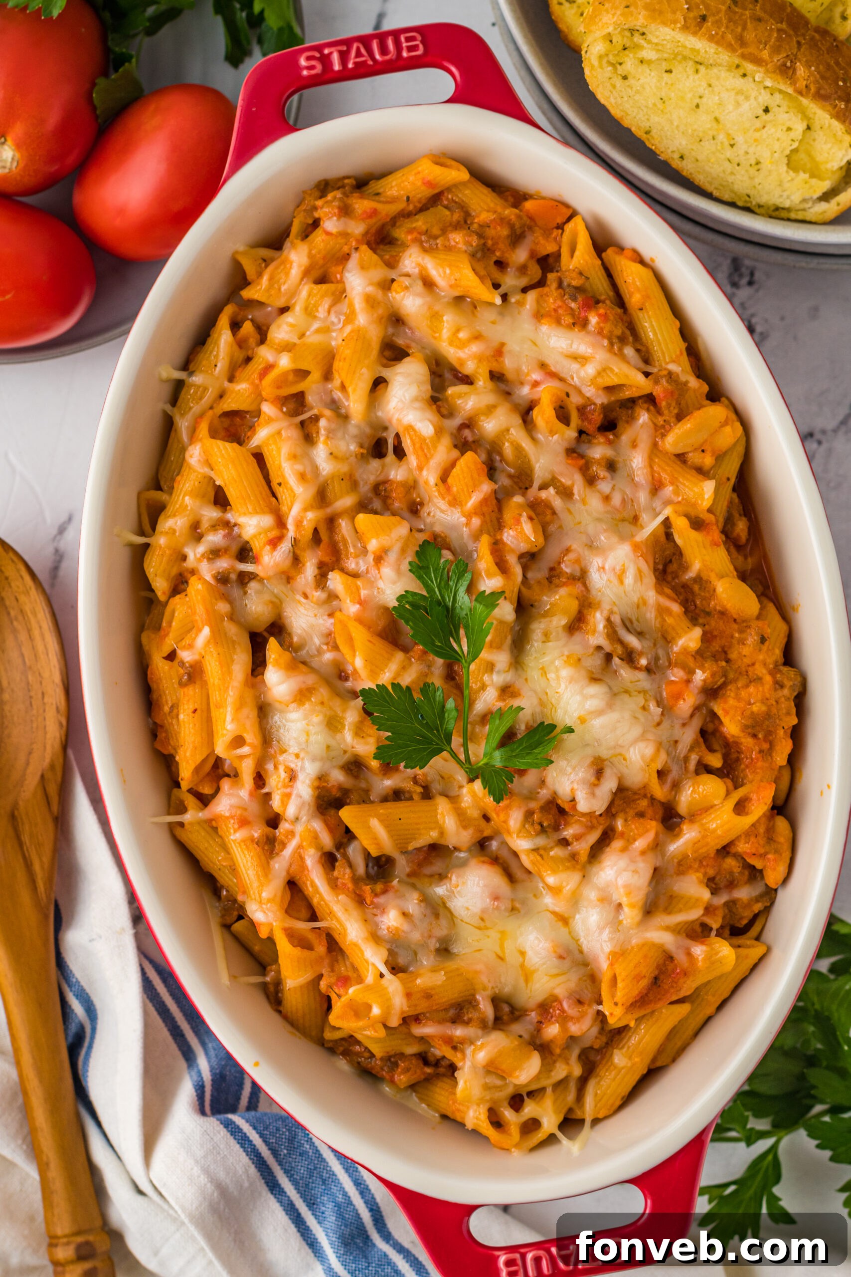 Pasta Fagioli Bake 2 Overhead view of Pasta Fagioli al Forno in a baking dish, showcasing its golden-brown cheese topping and rich, bubbling sauce.