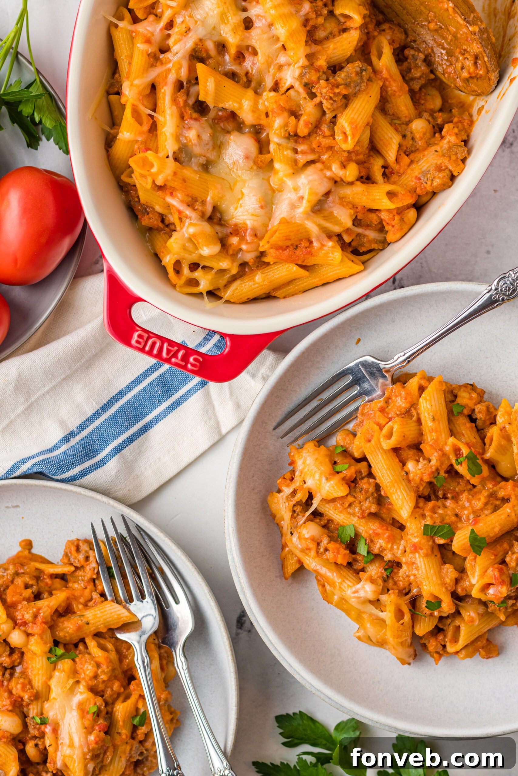 Pasta Fagioli Bake 15 Overhead view of two servings of Pasta Fagioli al Forno on two gray dishes with silver forks, inviting and perfectly portioned.
