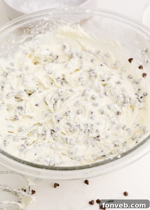 A vibrant lemon, ready for zesting, beside a bottle of orange extract.