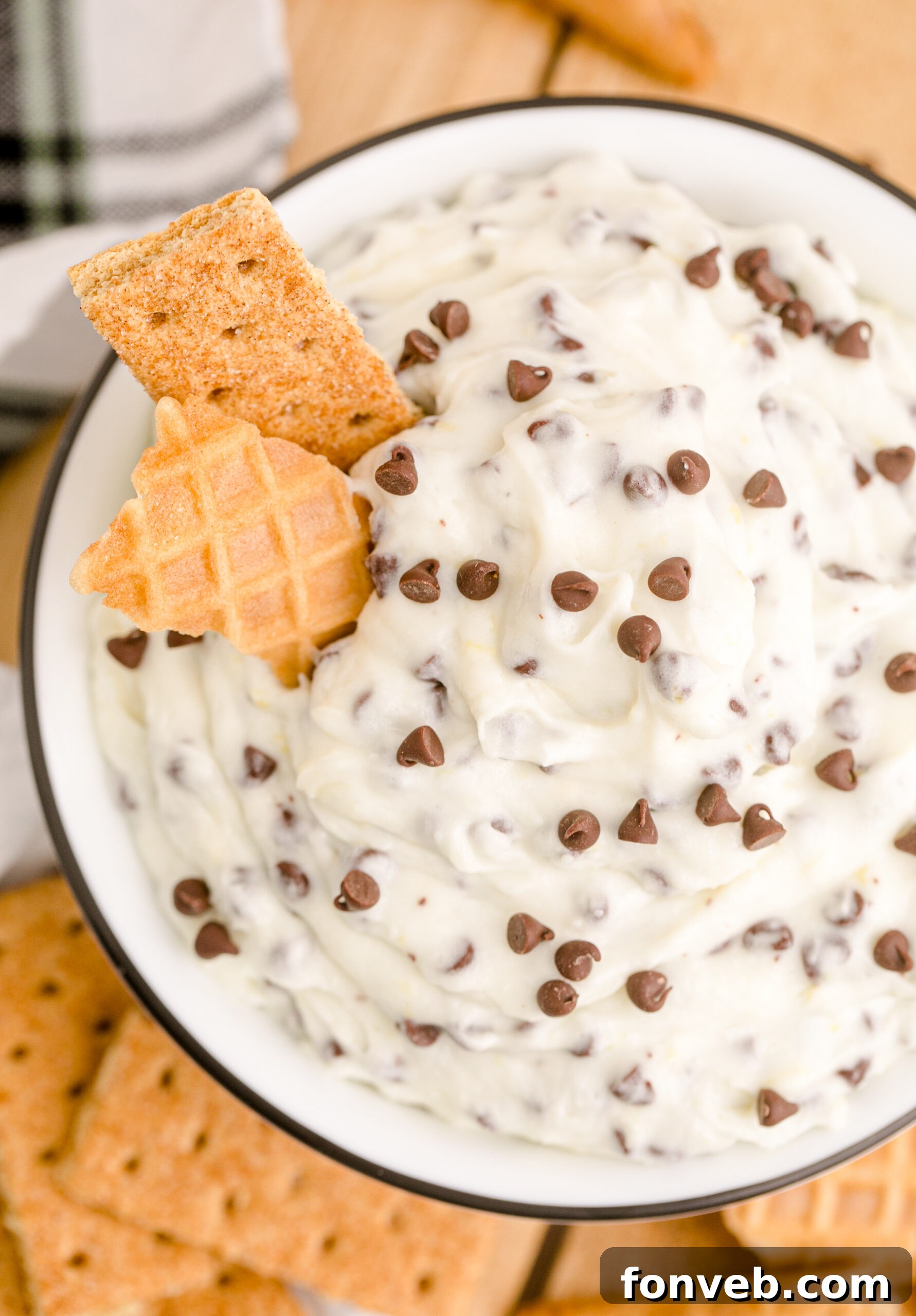 An overhead view of the delightful Cannoli Dip, served with both a waffle cone and graham cracker, inviting a double dip.