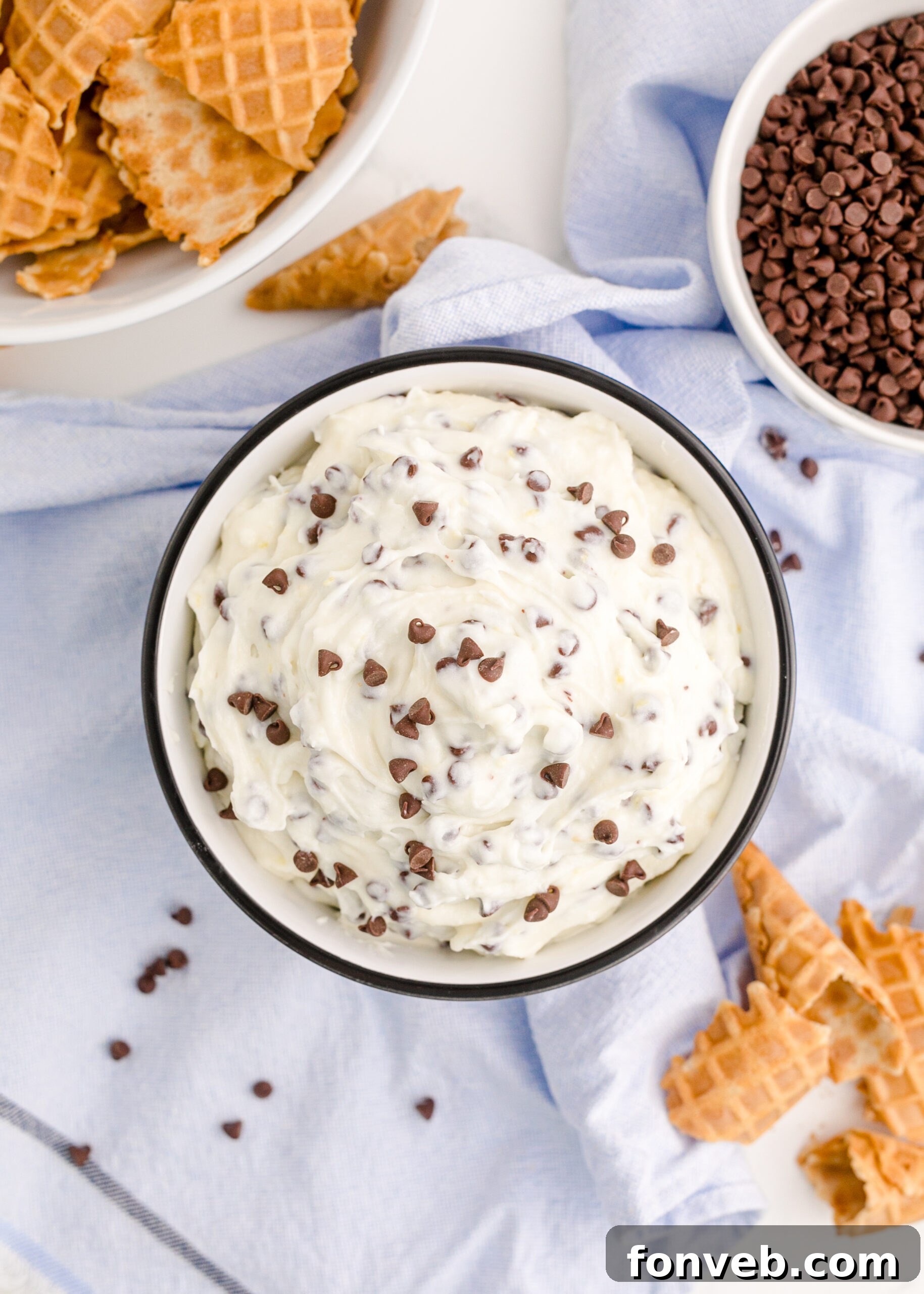 A pristine overhead shot of the Cannoli Dip in a black and white ceramic bowl, showcasing its smooth, inviting texture.