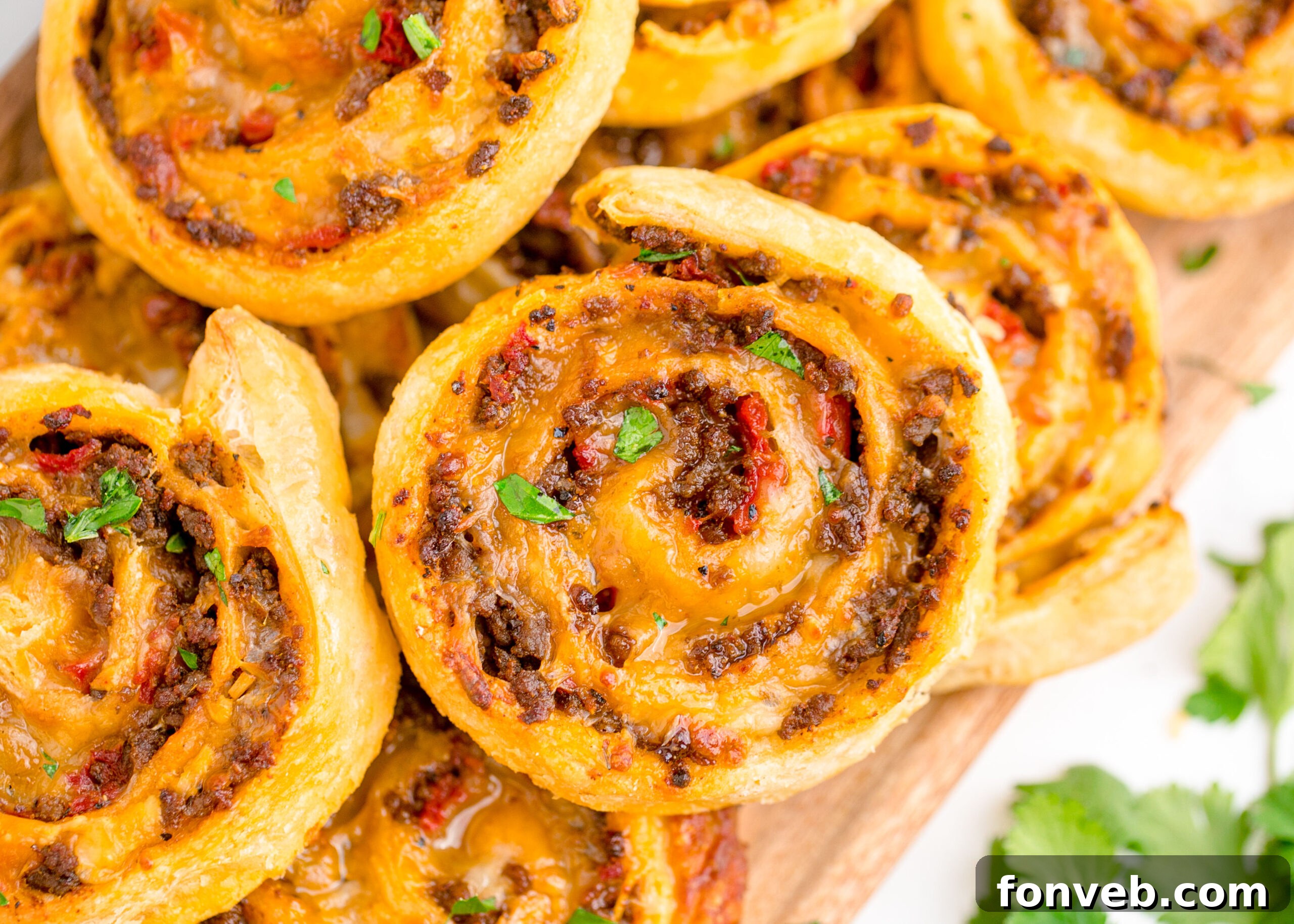 Taco pinwheels up close showing the gooey cheese and beef inside