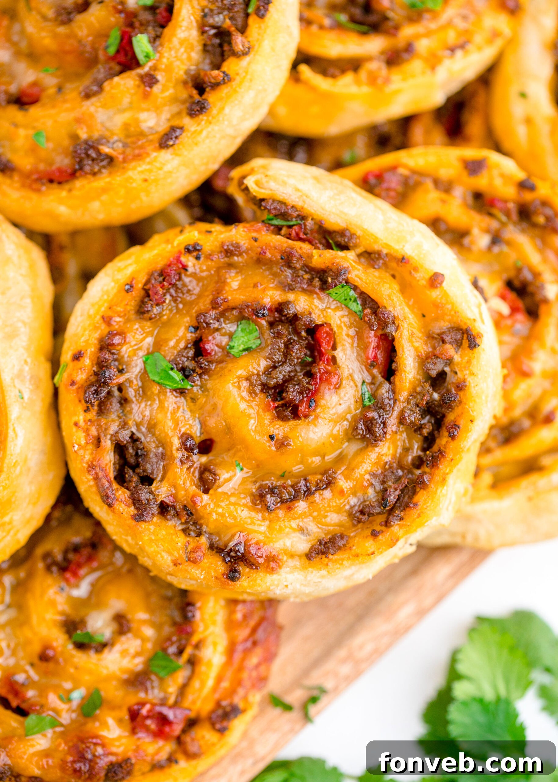 Taco pinwheels up close on a wood board