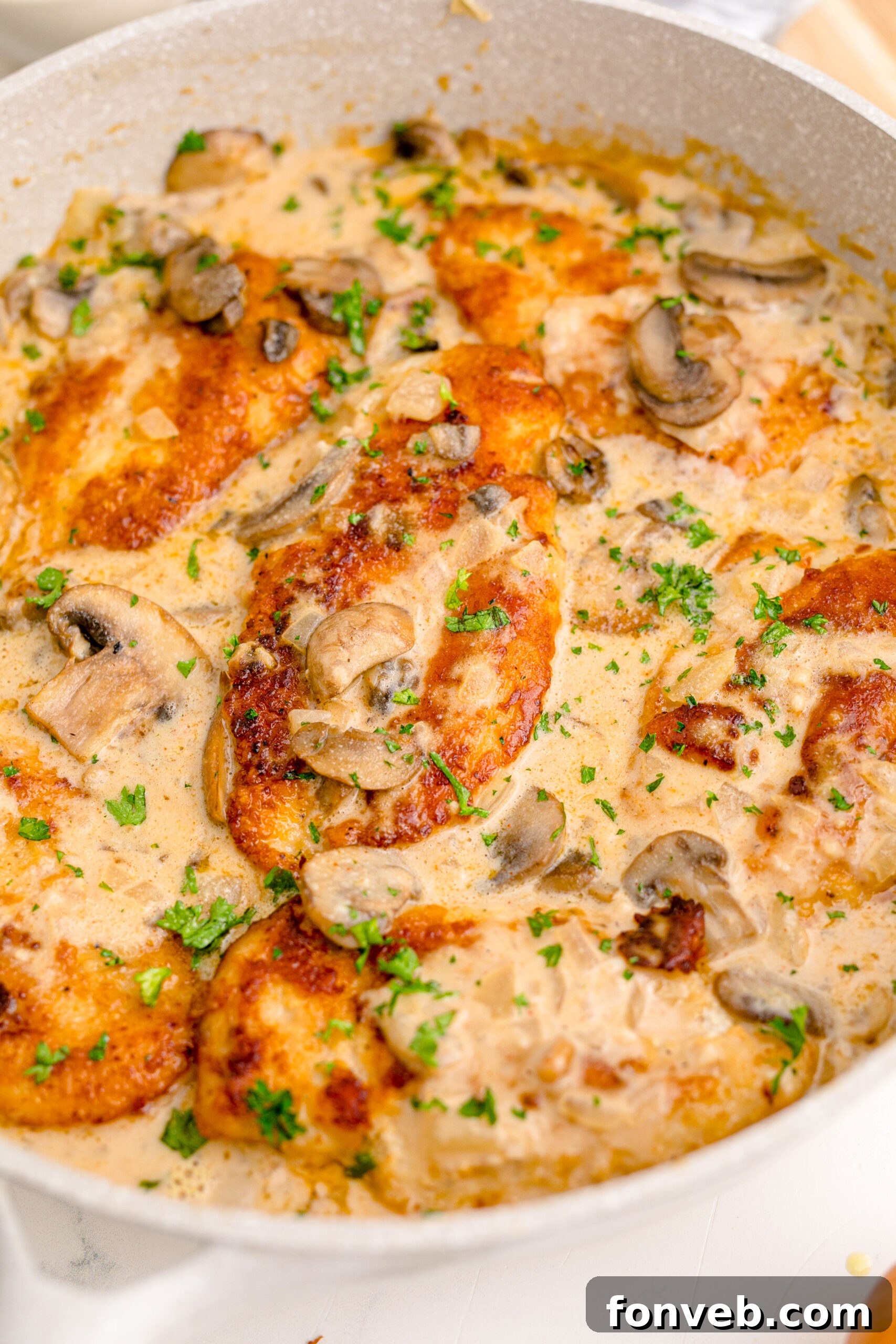 close up shot of the Chicken Marsala in a white skillet 