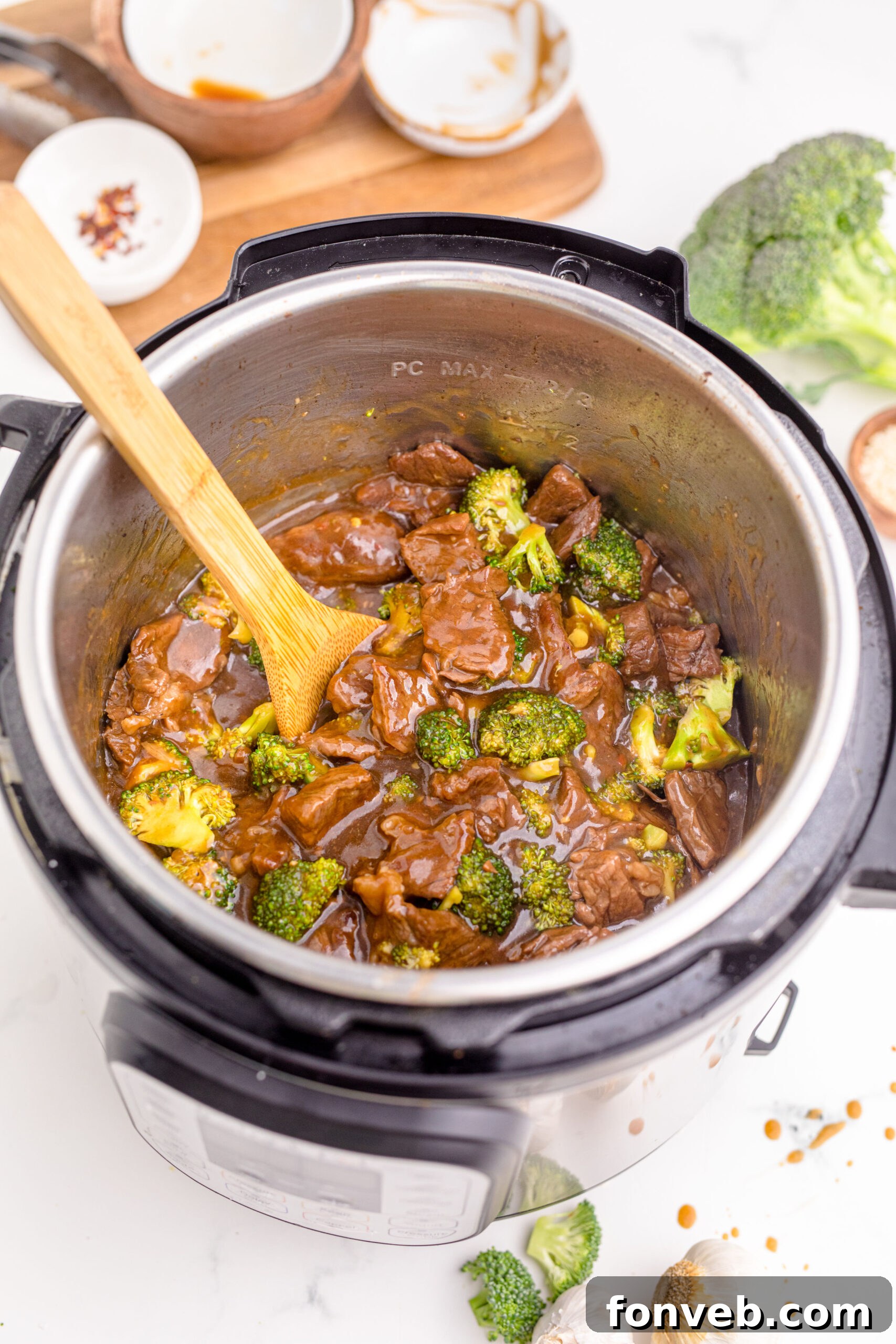 Instantpot Beef & Broccoli in the instantpot showing how delicious with a wooden spoon in the pot 