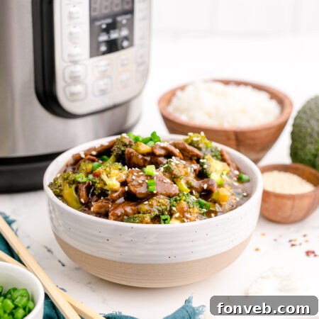 Instant Pot Beef and Broccoli in a white and tan bowl.