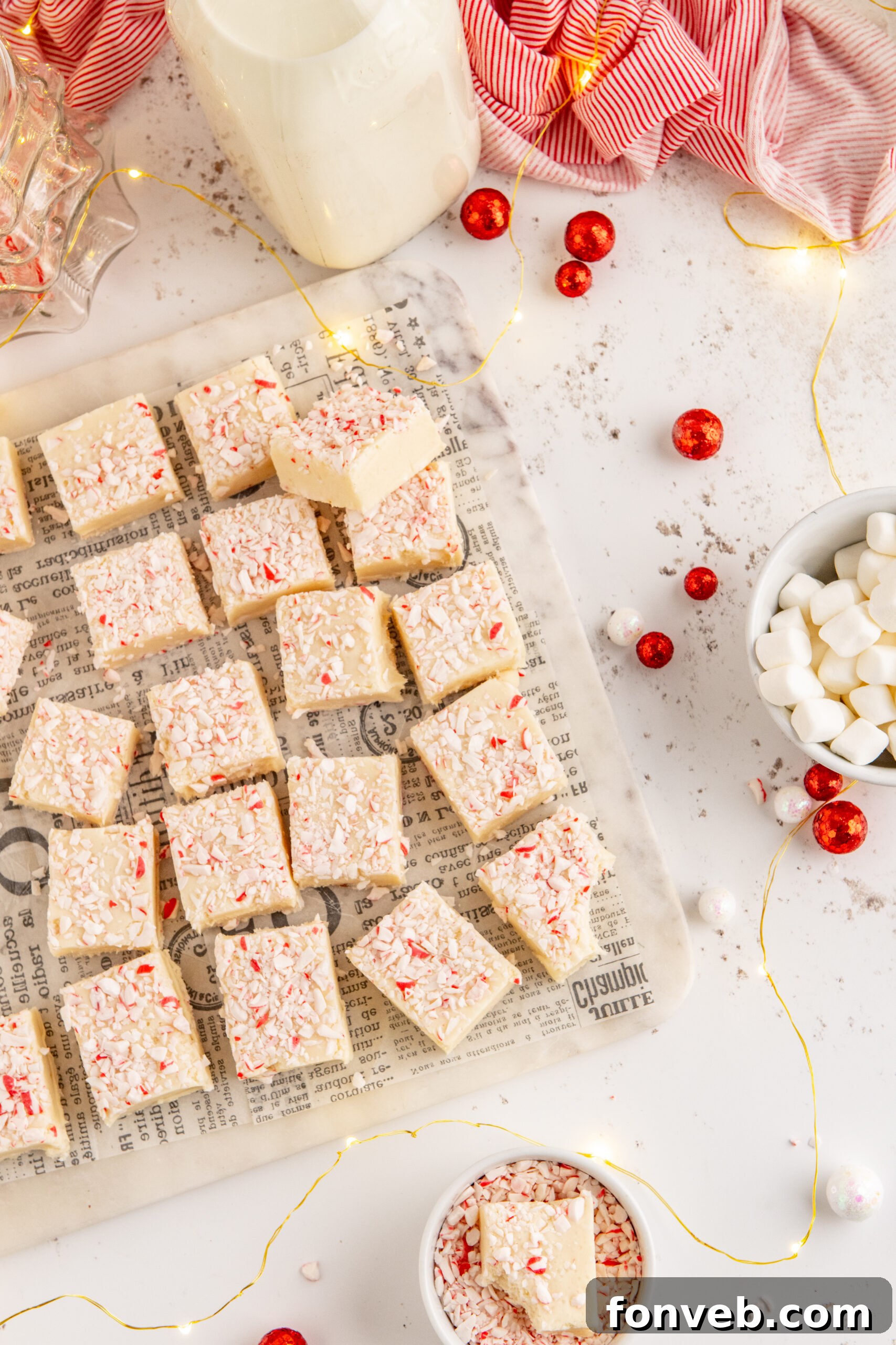 Peppermint fudge cut up into small squares topped with crushed peppermint.