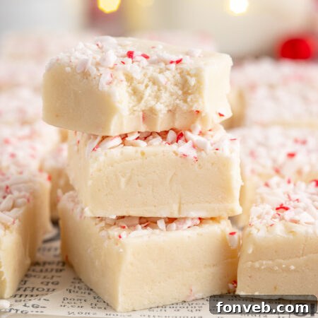 A block of white chocolate peppermint fudge cut into squares.