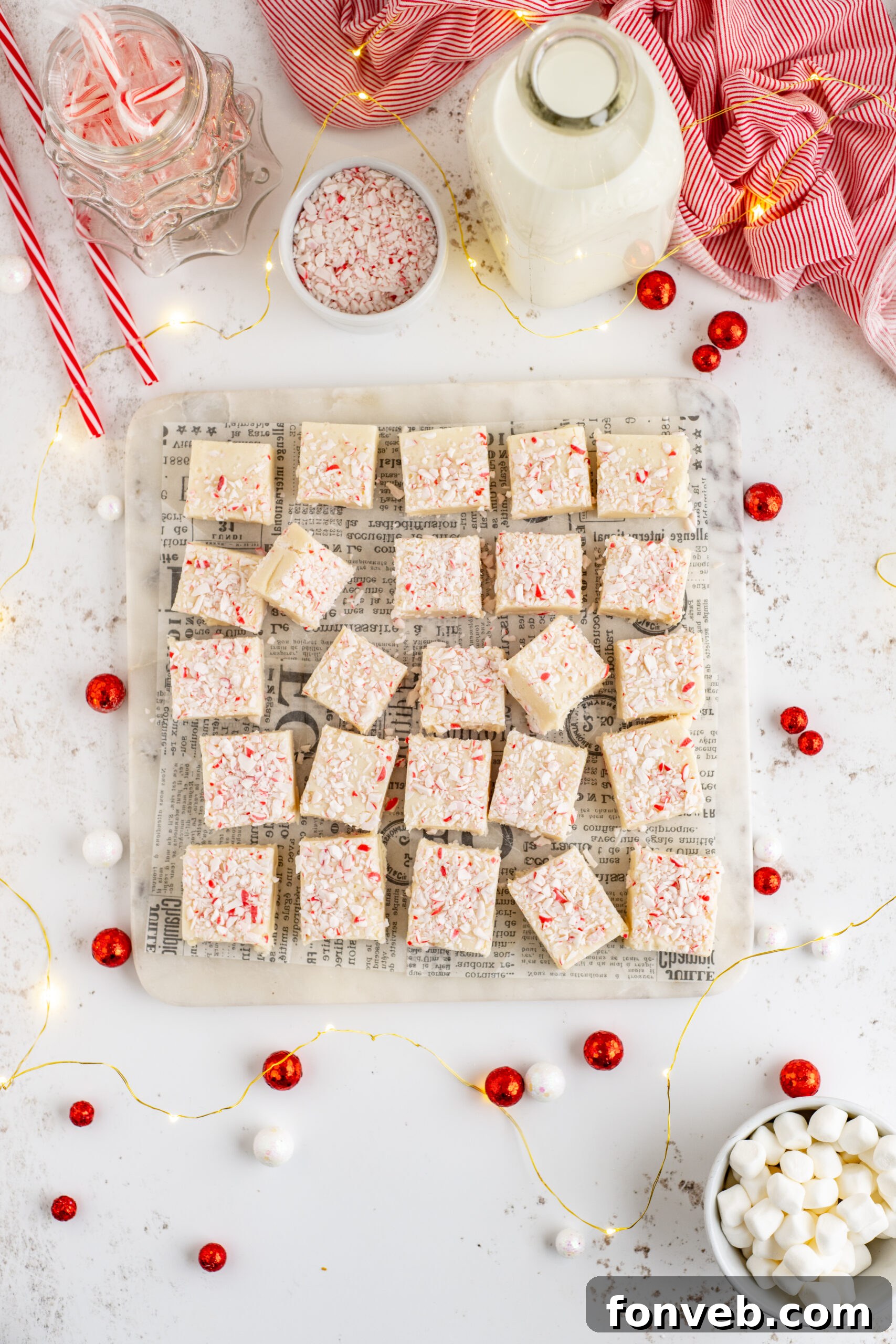 Peppermint fudge cut up into small squares topped with crushed peppermint.