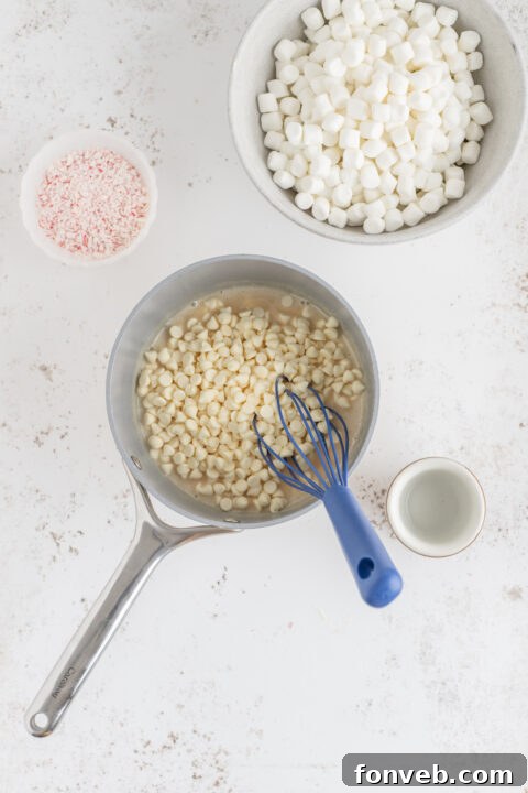 A person stirring melted ingredients in a saucepan for peppermint fudge.