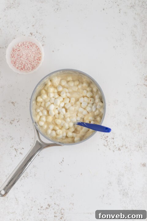 Melted fudge mixture in a saucepan, ready for marshmallows.