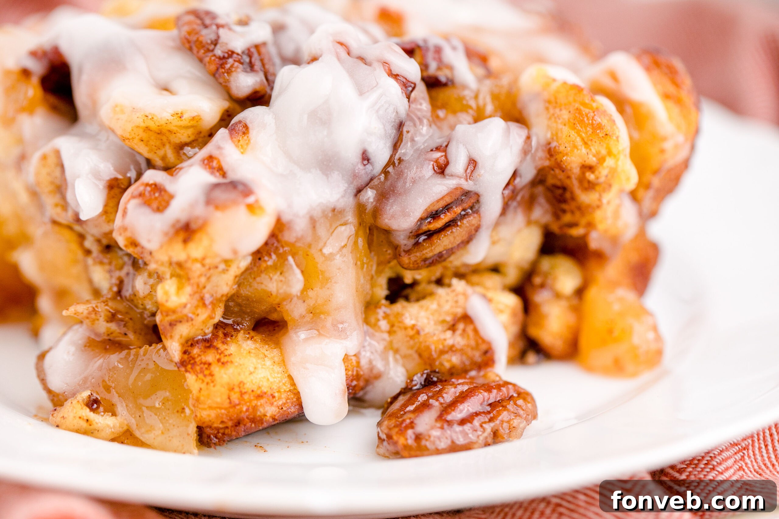 Irresistible Cinnamon Swirl Bake 16 Cinnamon Roll Casserole on a white plate .