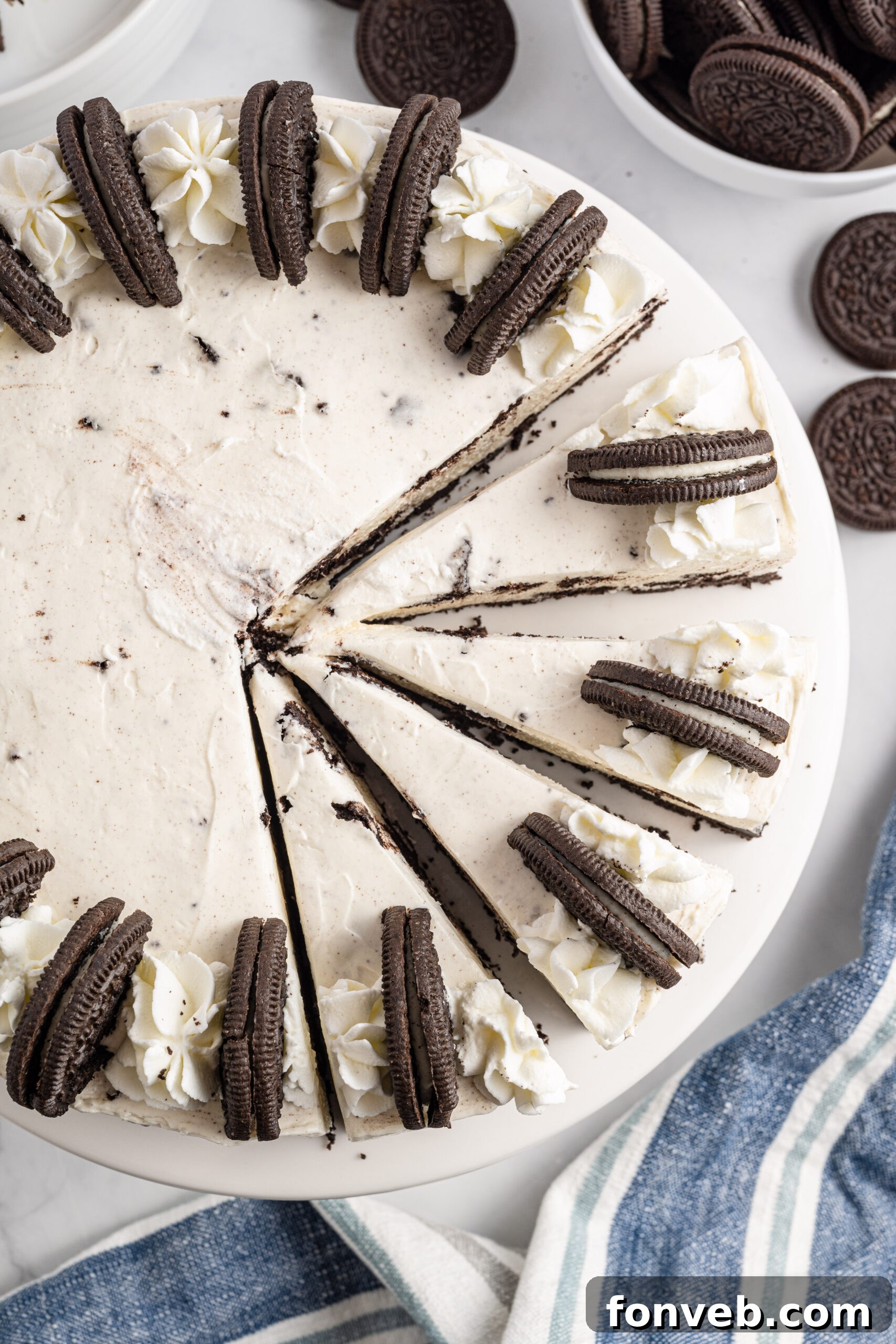Overhead view of No Bake Oreo Cheesecake with four slices neatly cut, highlighting the texture and topping.
