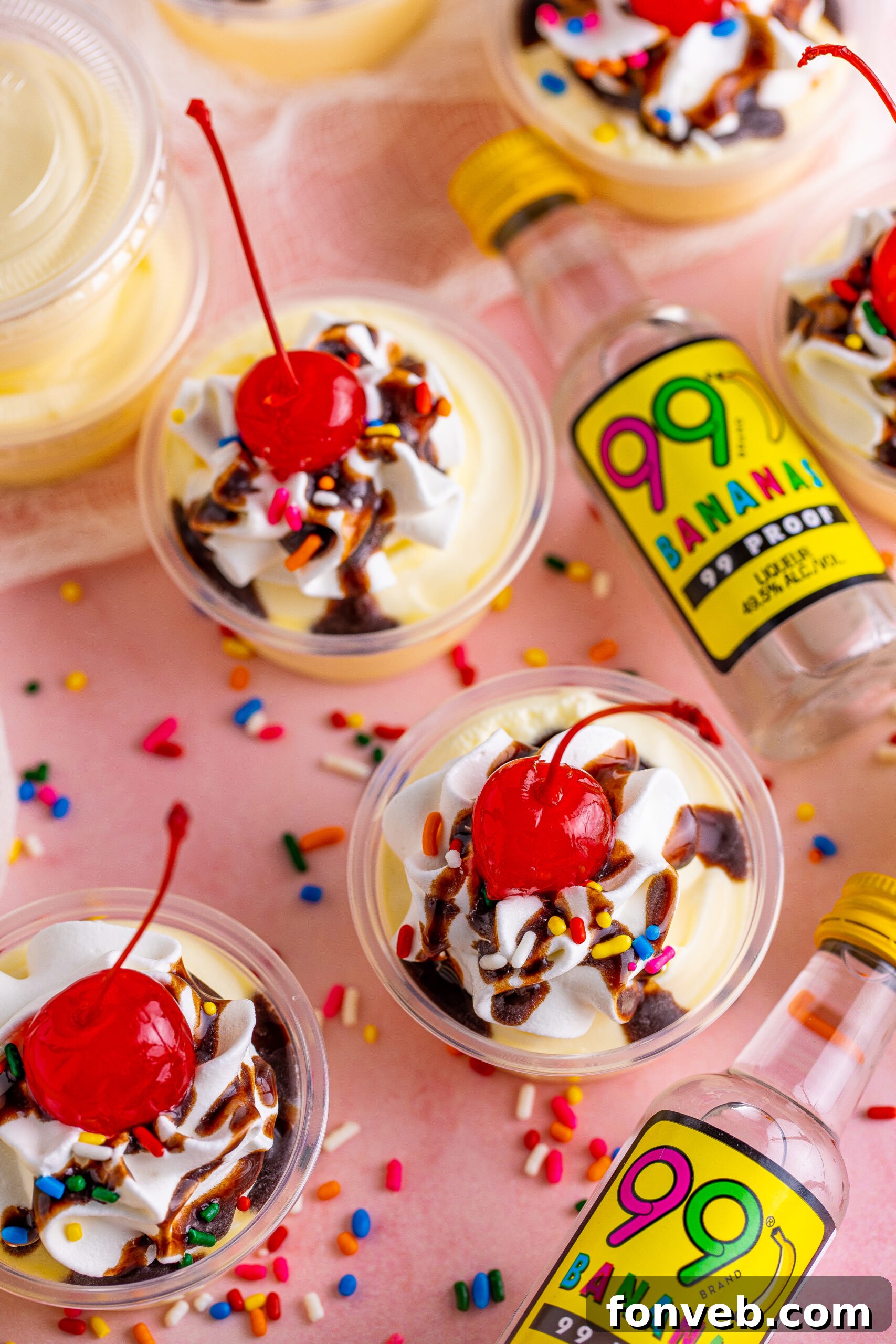 Mini Banana Split Delights 15 Overhead view of Banana Split Shots, beautifully garnished with rainbow sprinkles, awaiting consumption.